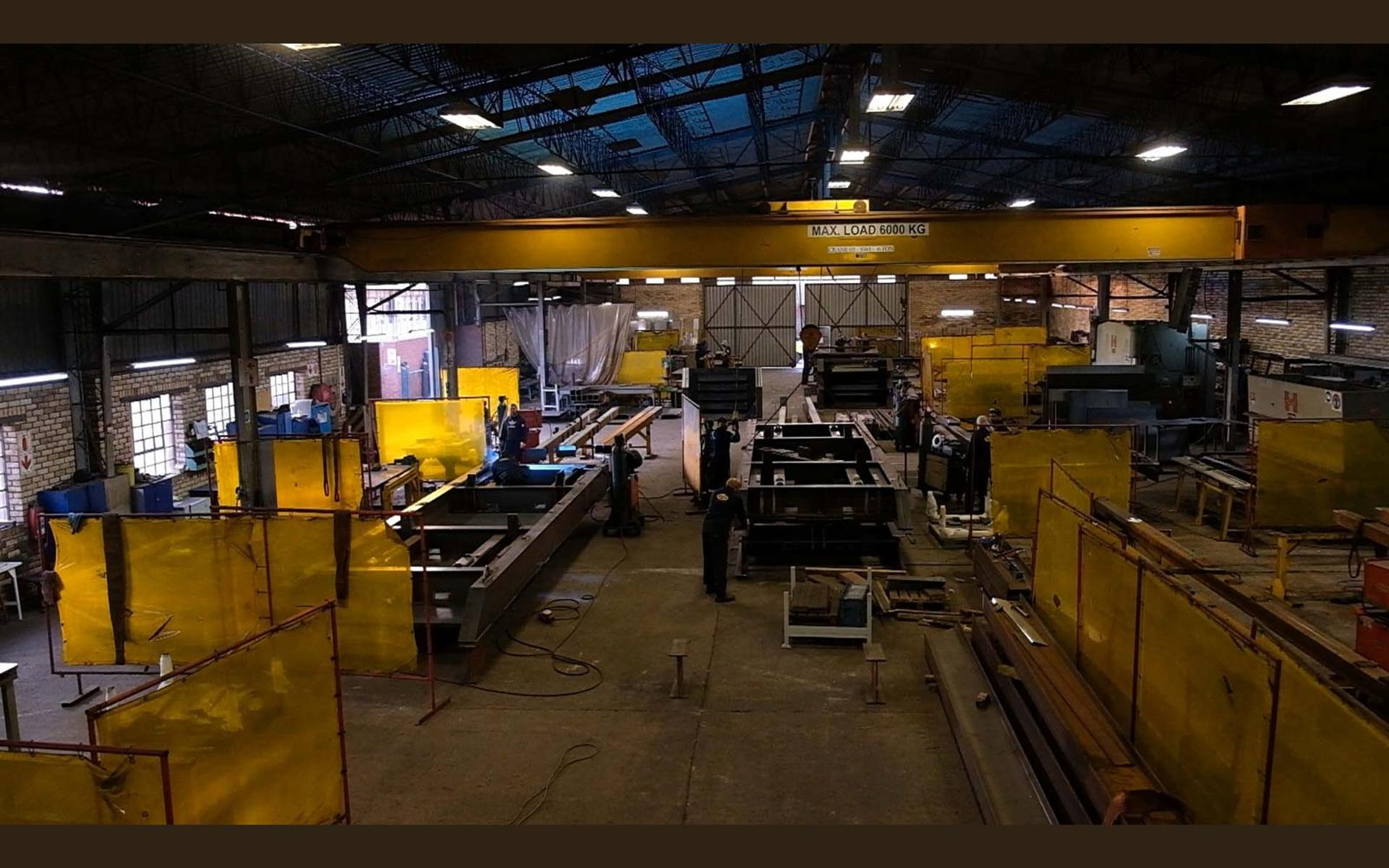 Steel frames laid out across the fabrication sector floor