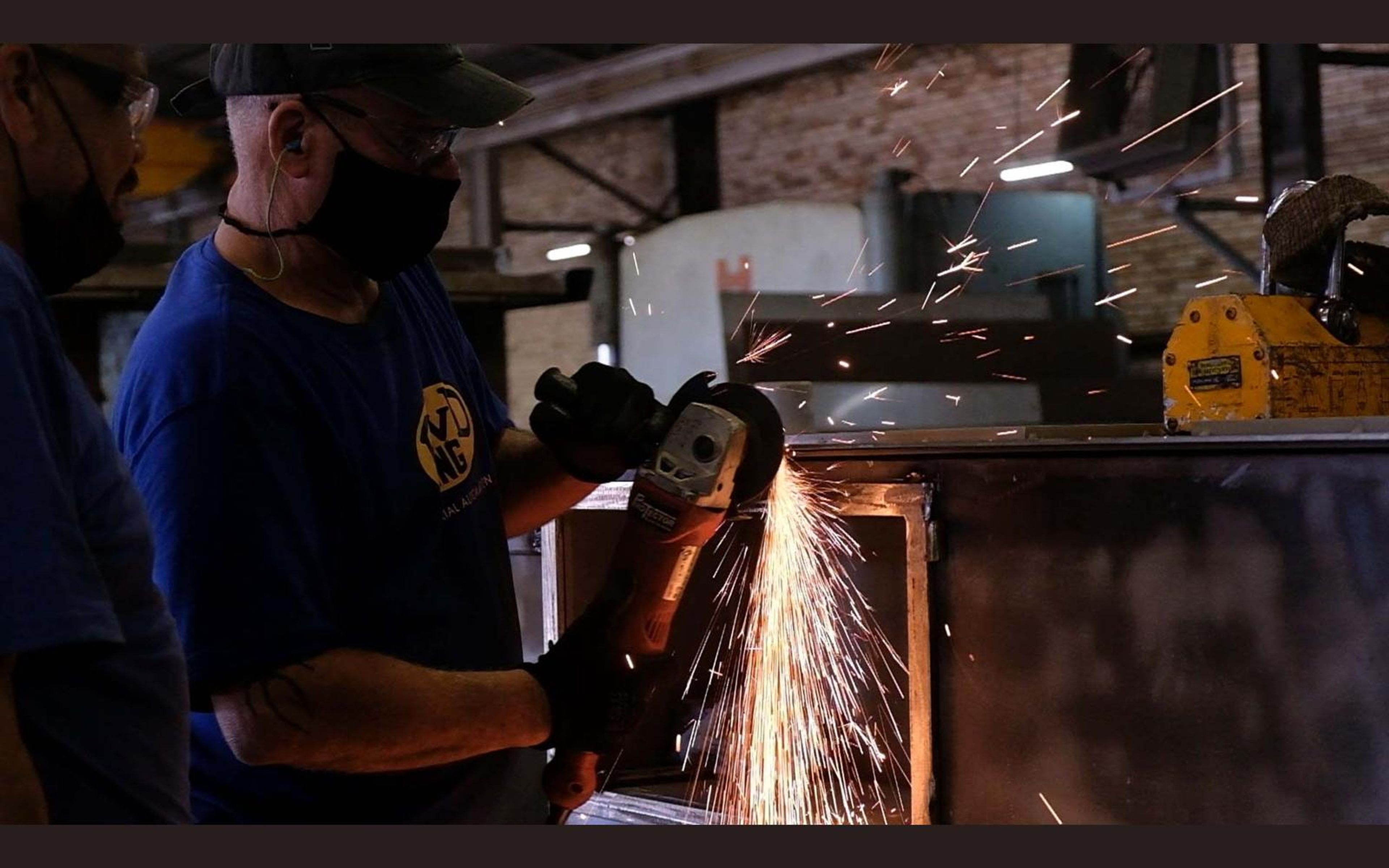 Hands working on a steel part in the fabrication sector