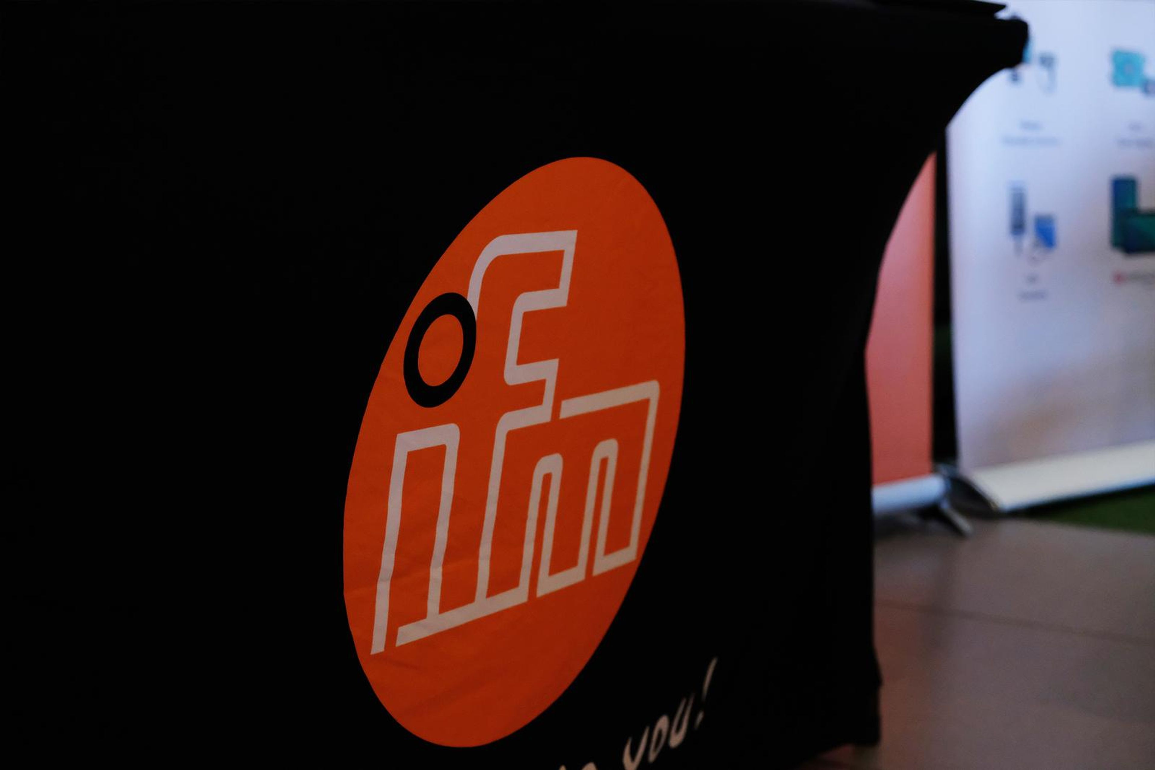 IFM logo on the stand's black table cover