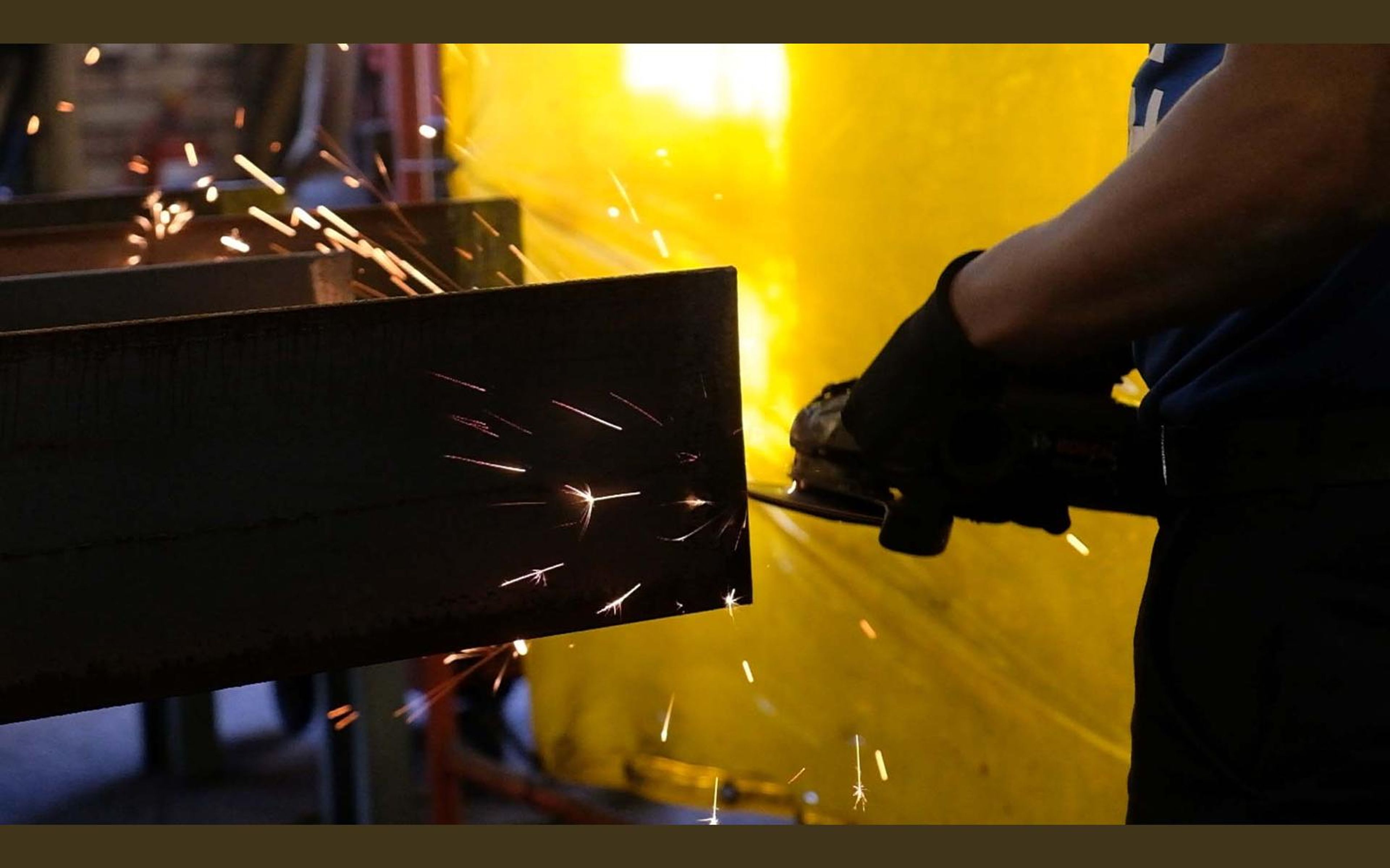 Grinder throwing sparks across steel