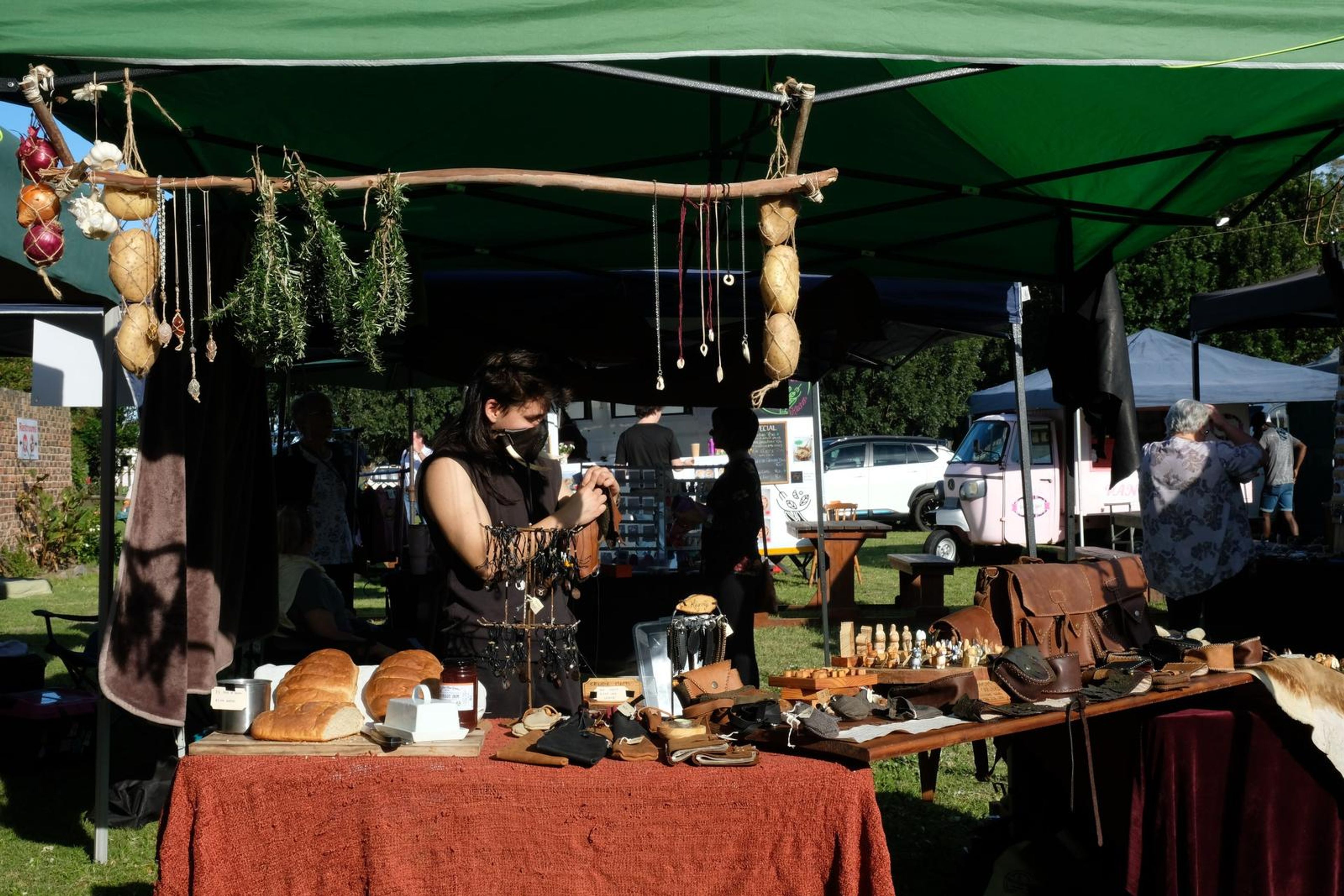 Juuks stall at Windsong Boho market with the maker working behind the display