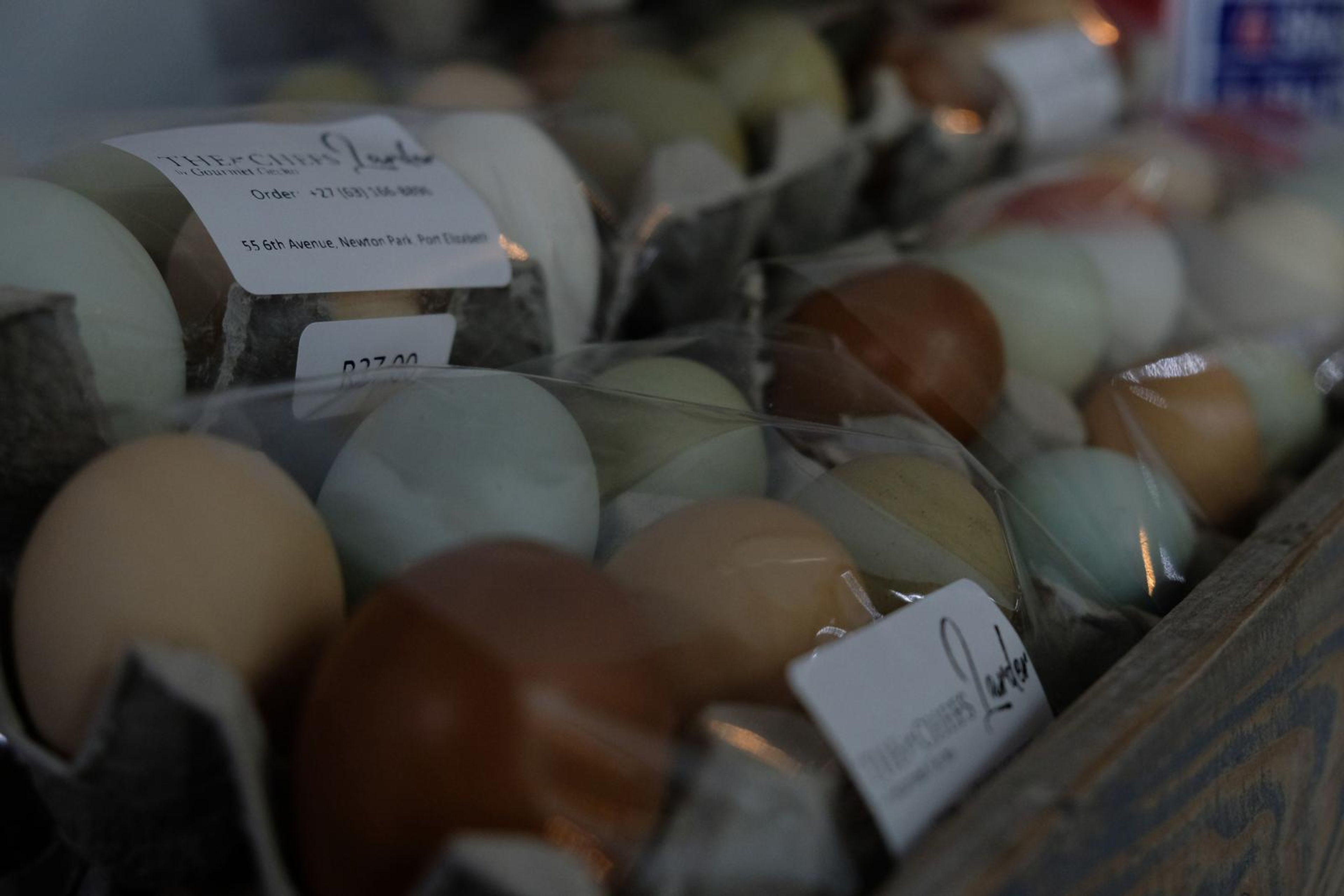 Trays of farm eggs in blue, cream and brown shades with Larder labels