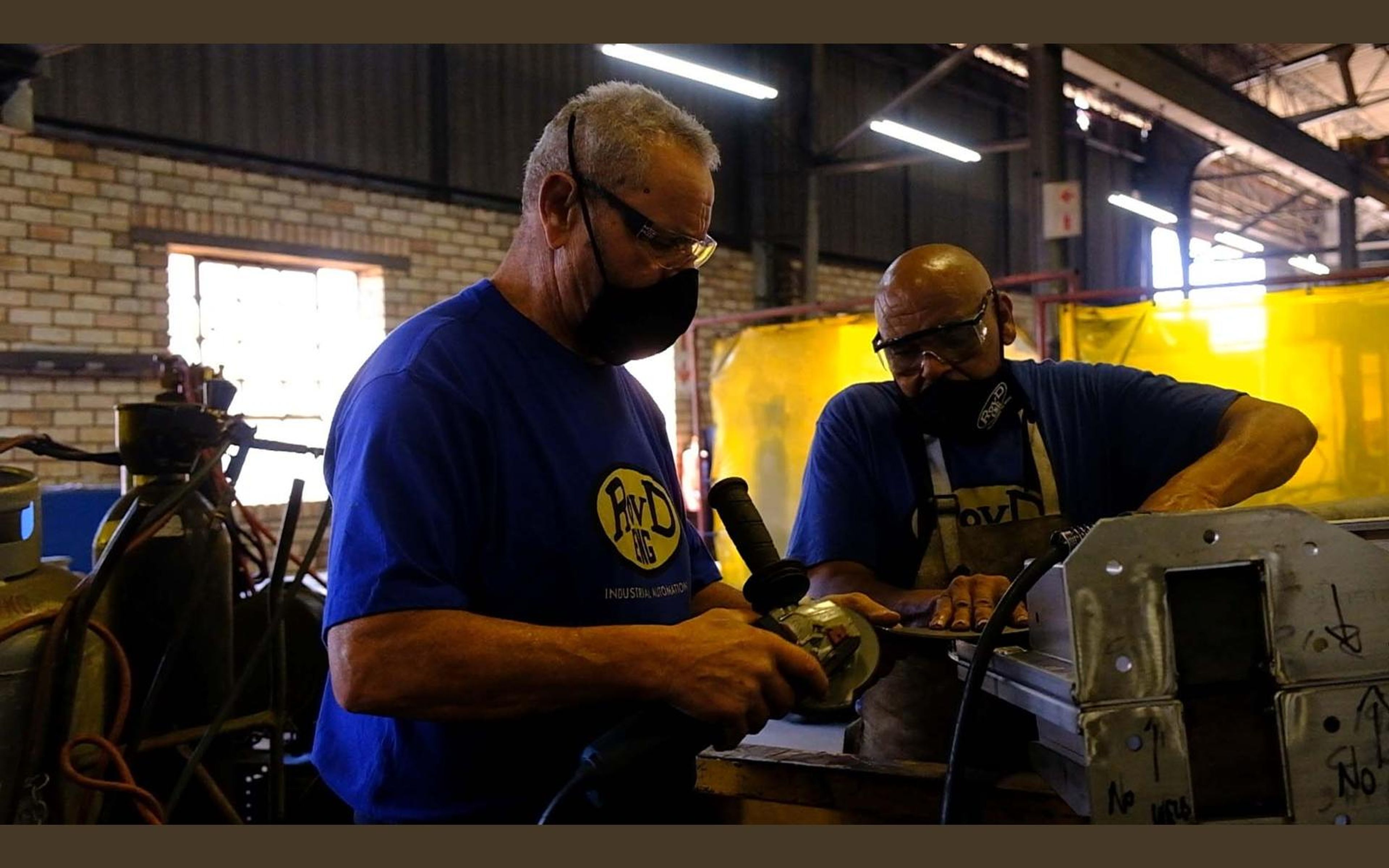 Team members working on a steel assembly