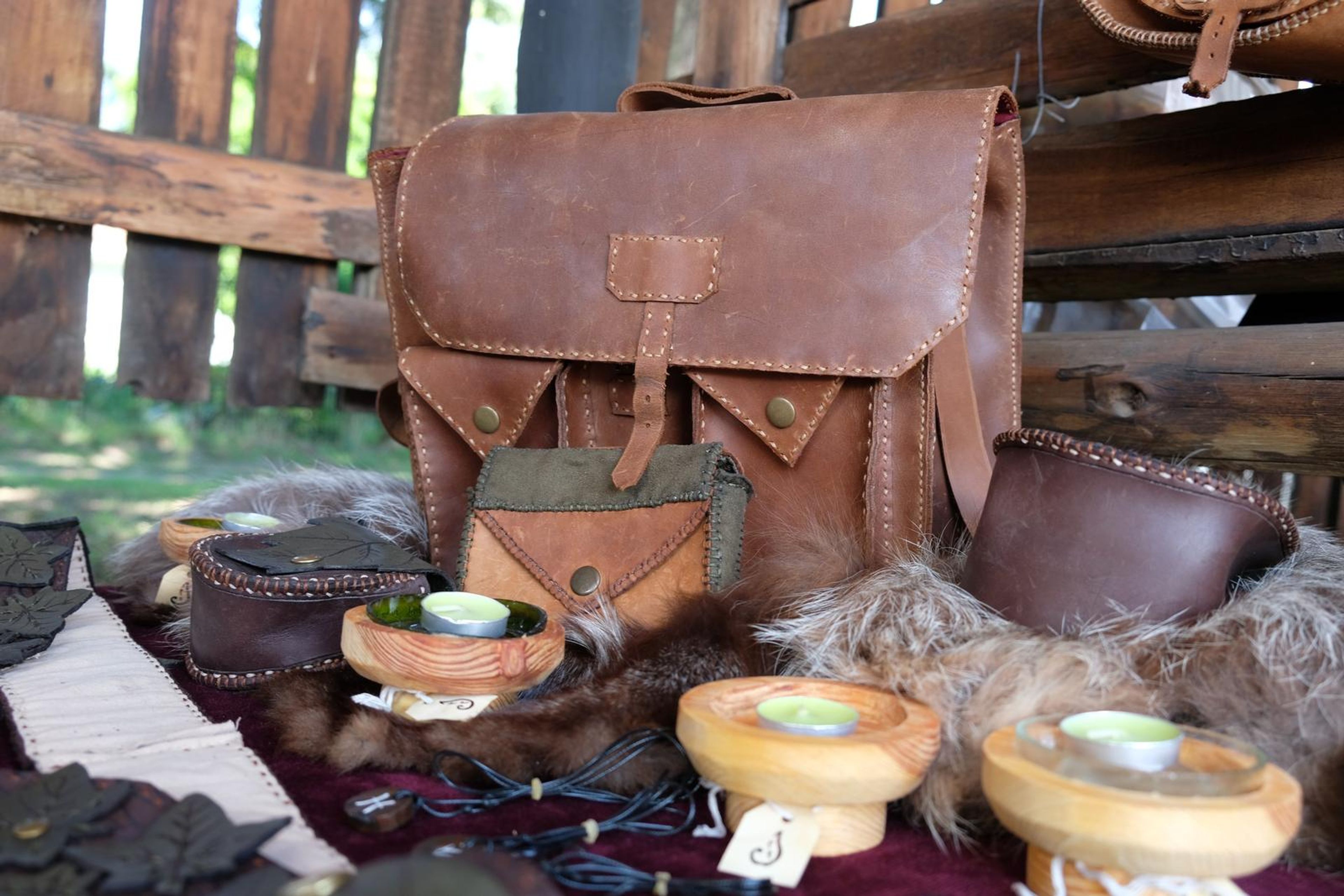 Handmade leather satchel and pouches displayed on furs and cloth at the Juuks stall