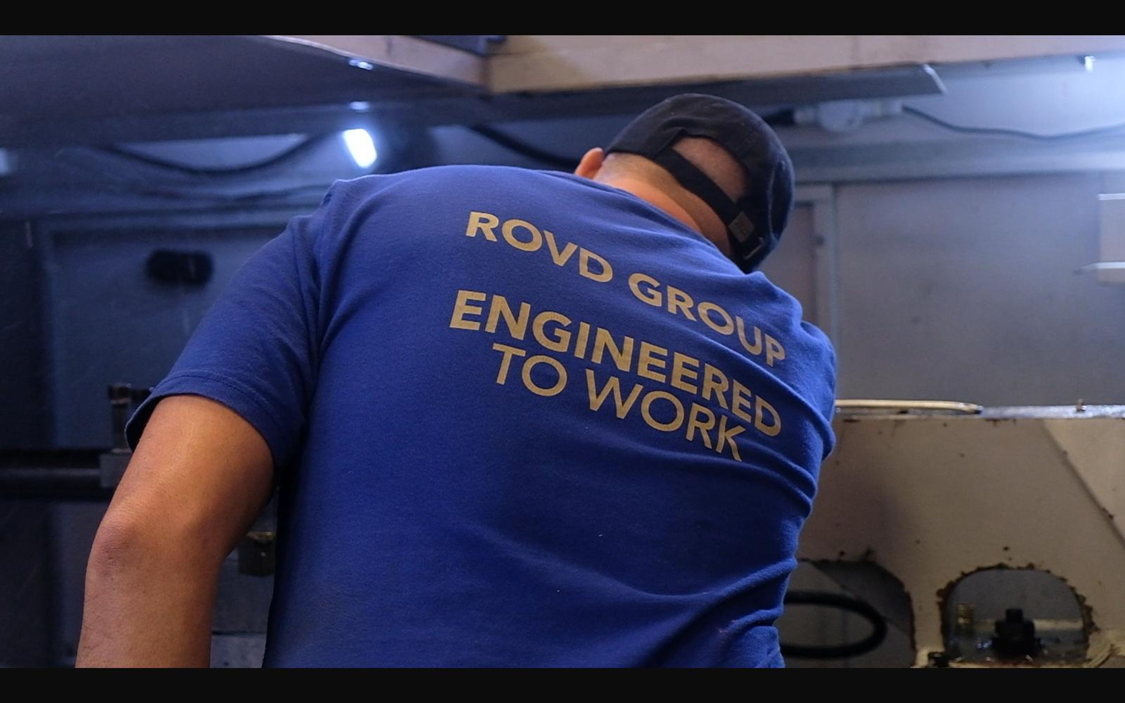 Machinist at the lathe seen from behind
