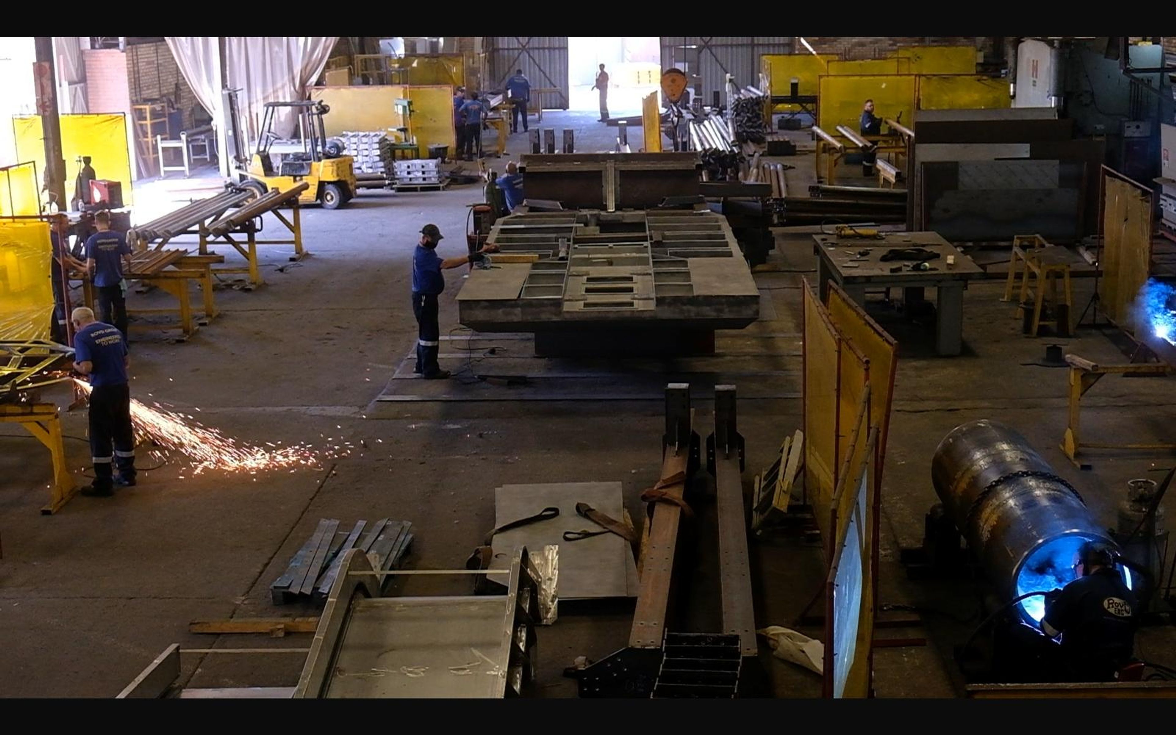 Overview of the fabrication shop with sparks and cylinders
