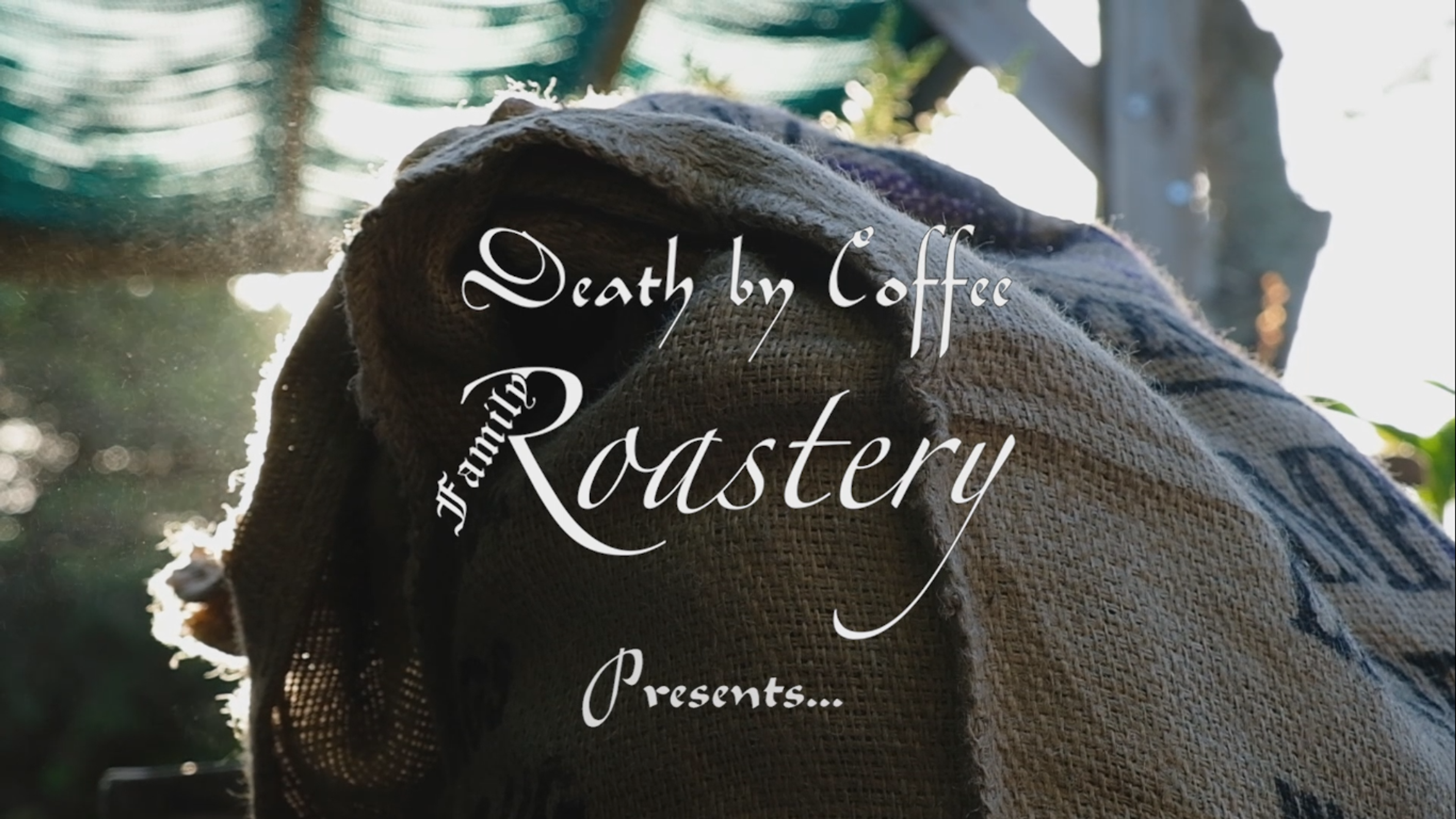 Video title card over a sunlit burlap coffee sack reading 'Death by Coffee Family Roastery Presents...'
