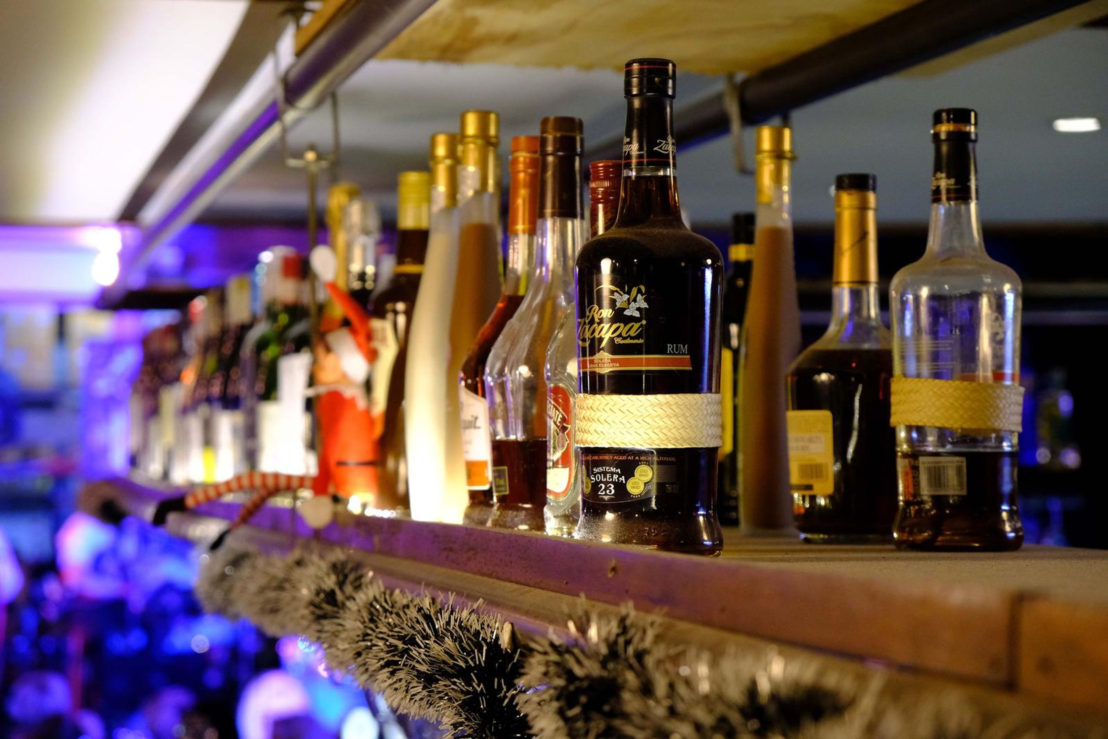 Bottles on the bar glowing in the festive lights