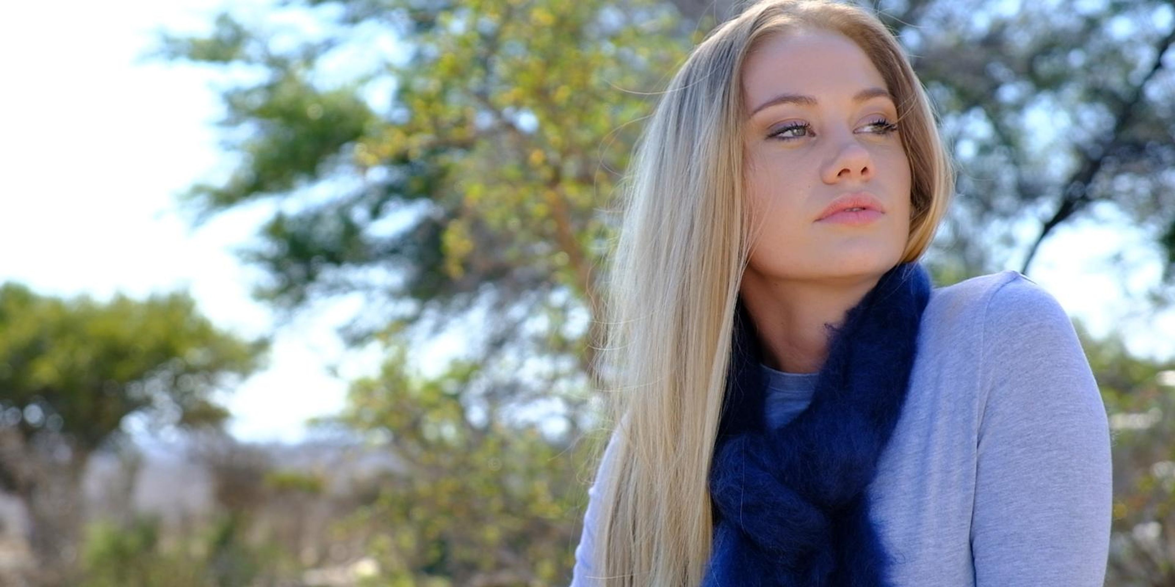 Model in a deep blue mohair scarf in warm light