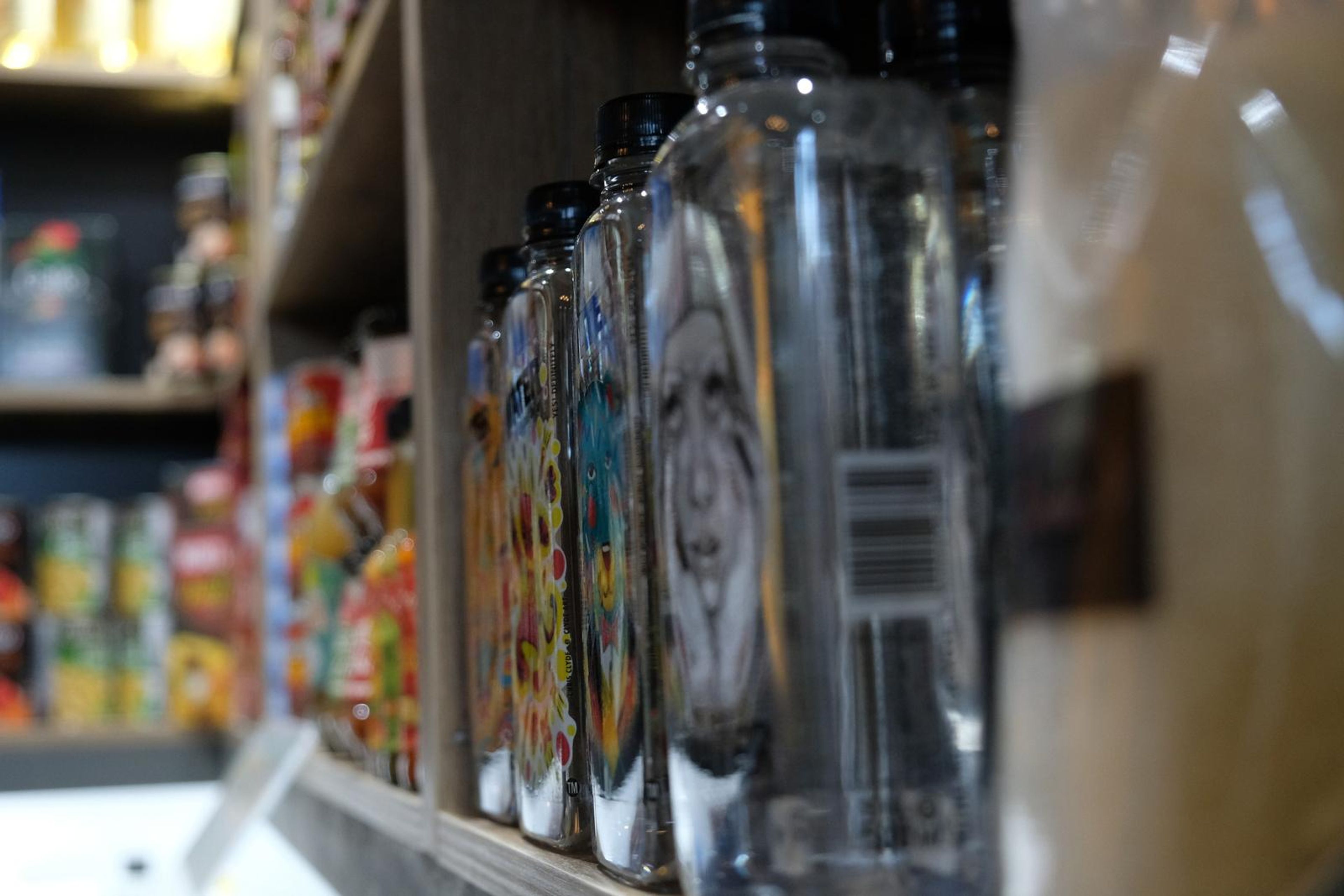 Illustrated Water bottles on a shelf beside tinned goods