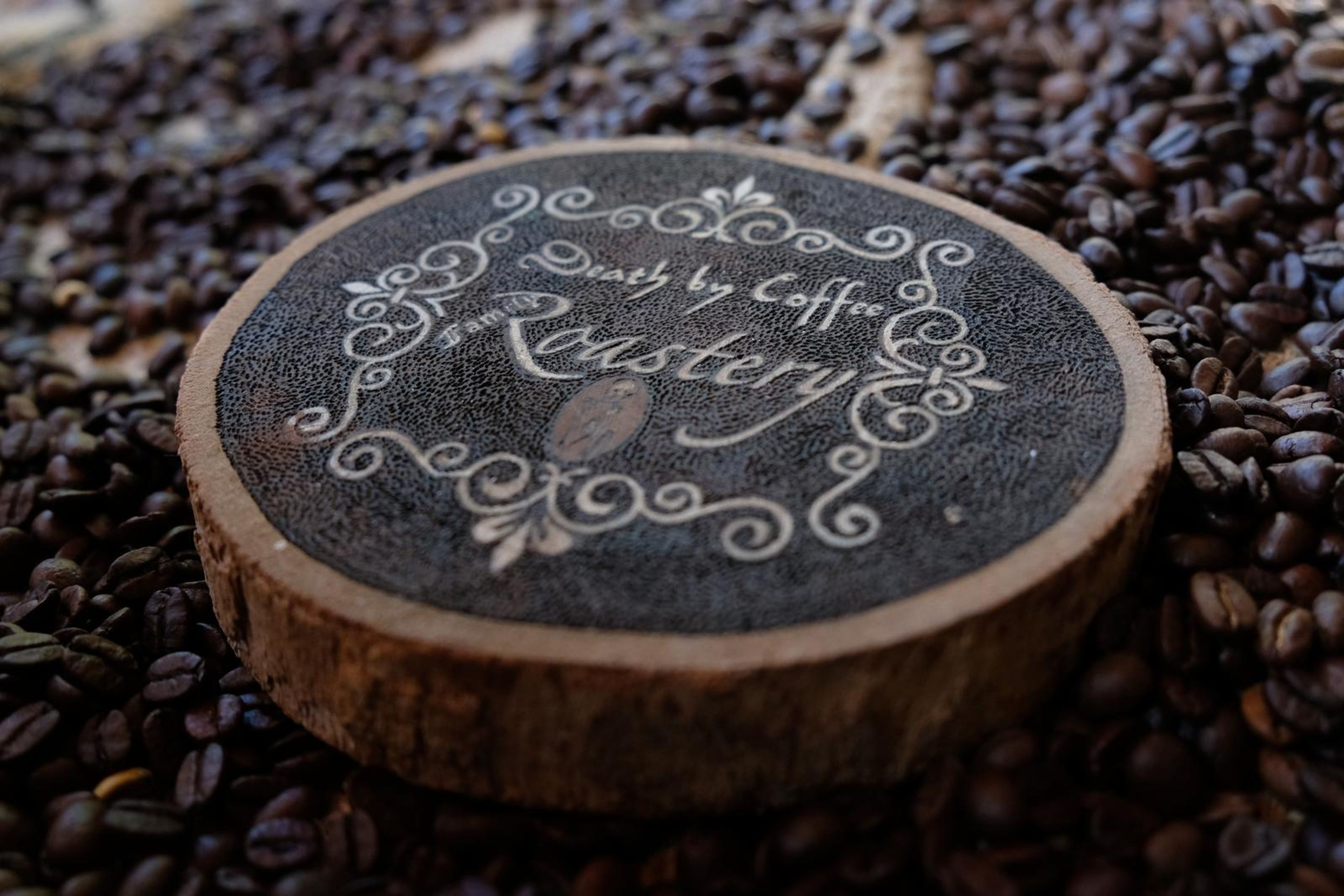 Death By Coffee creative product photography of coffee, beans and branded bags