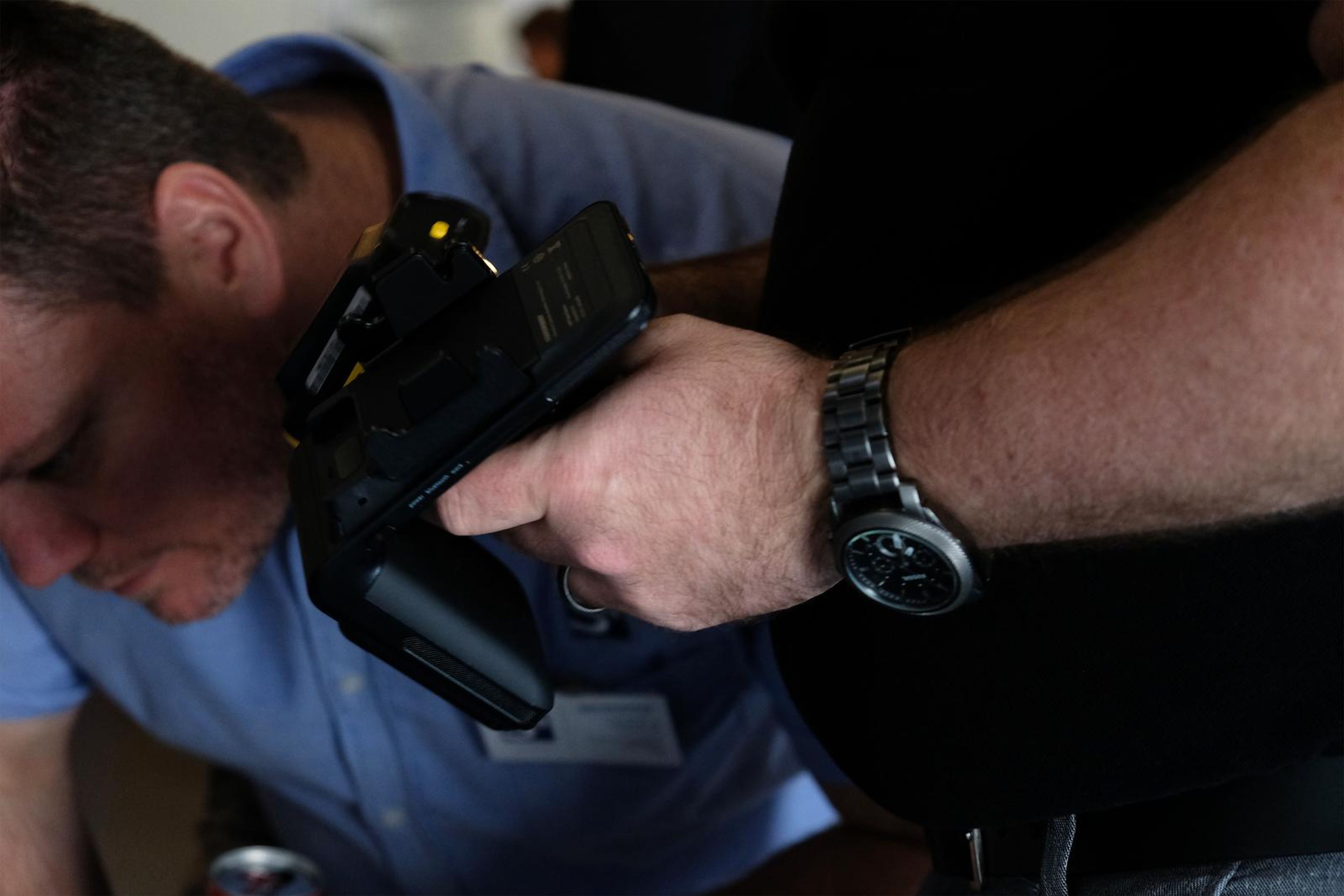 Visitor inspecting a handheld scanner