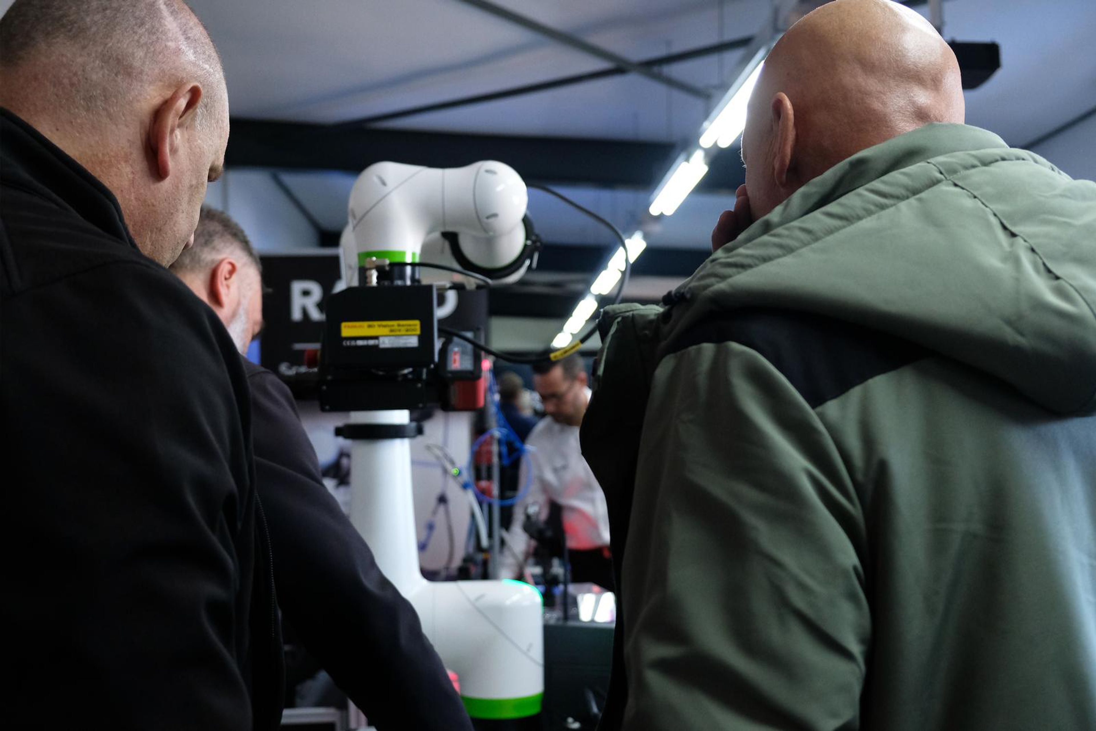 Visitors watching a Fanuc collaborative robot at work