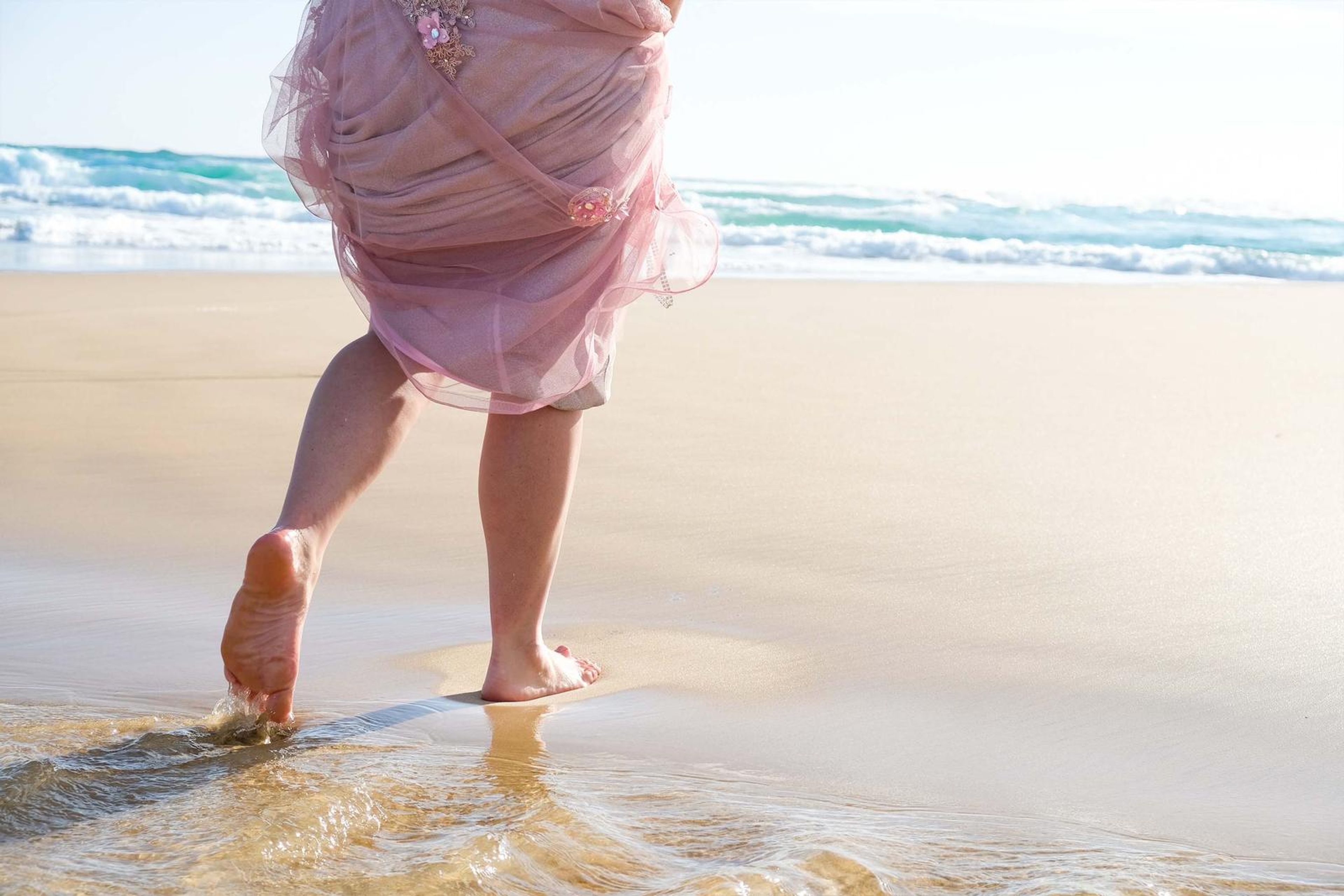 Bare feet splashing through shallow water