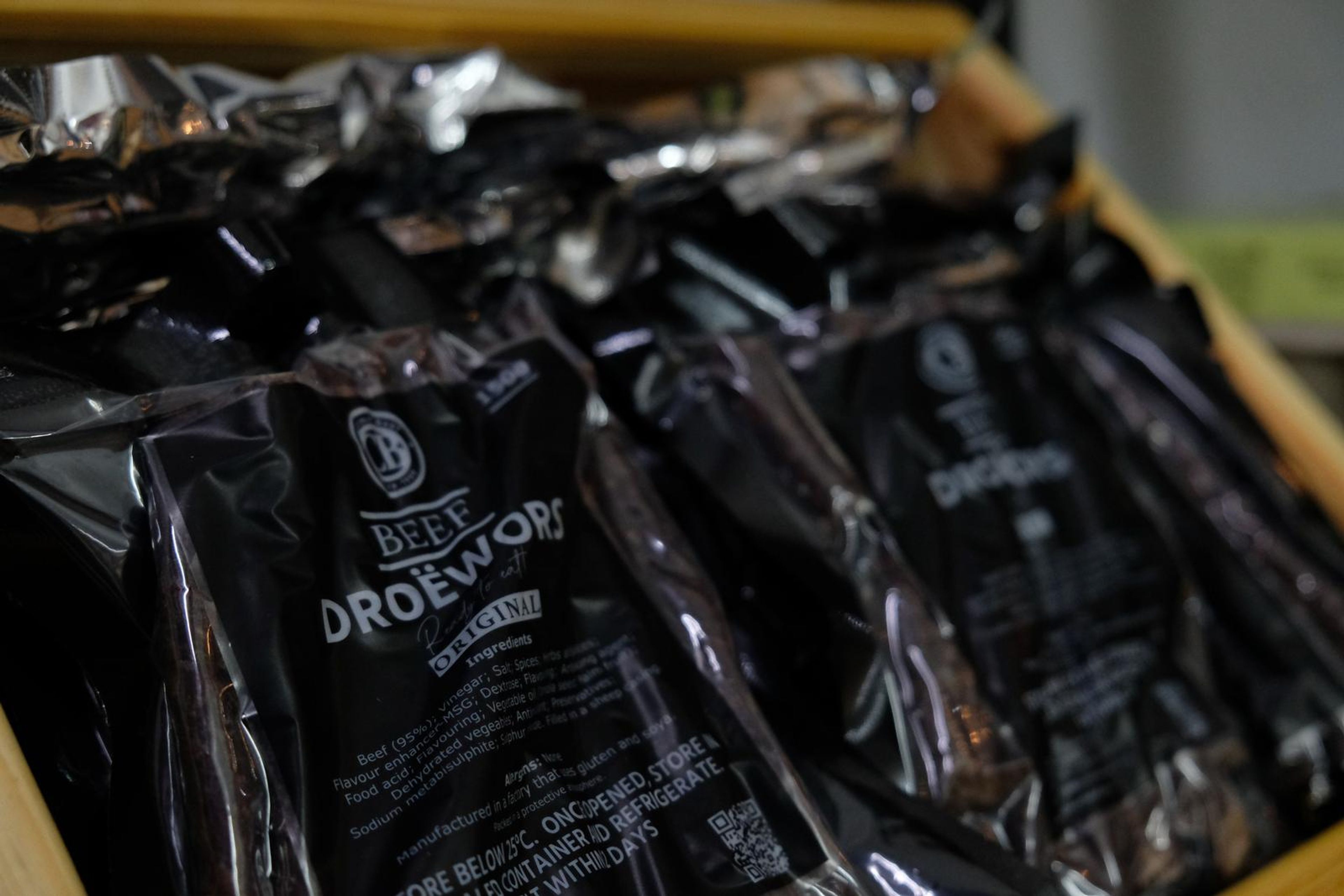 Bags of biltong and droewors in a wooden crate