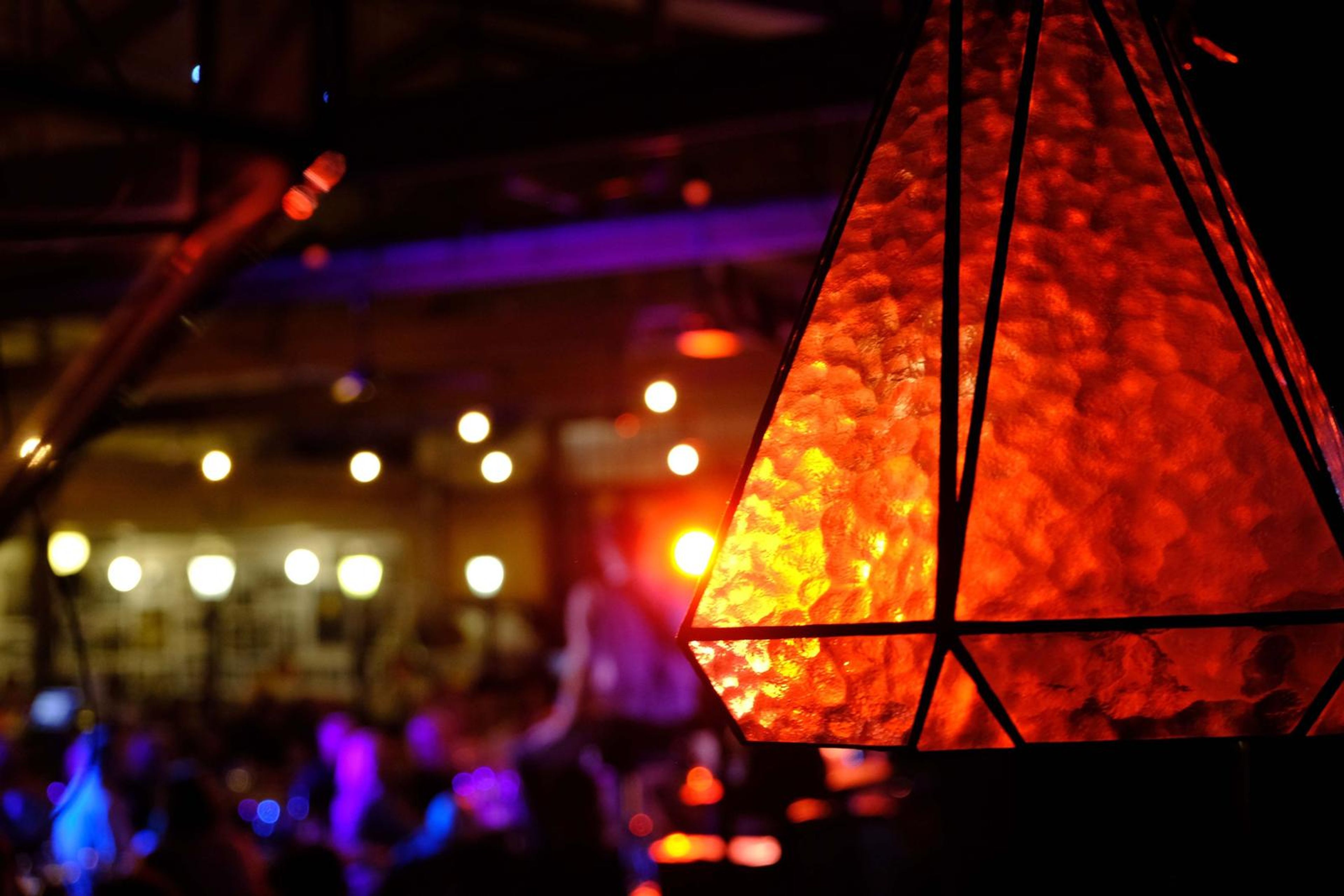 Orange stained-glass lantern above the crowd