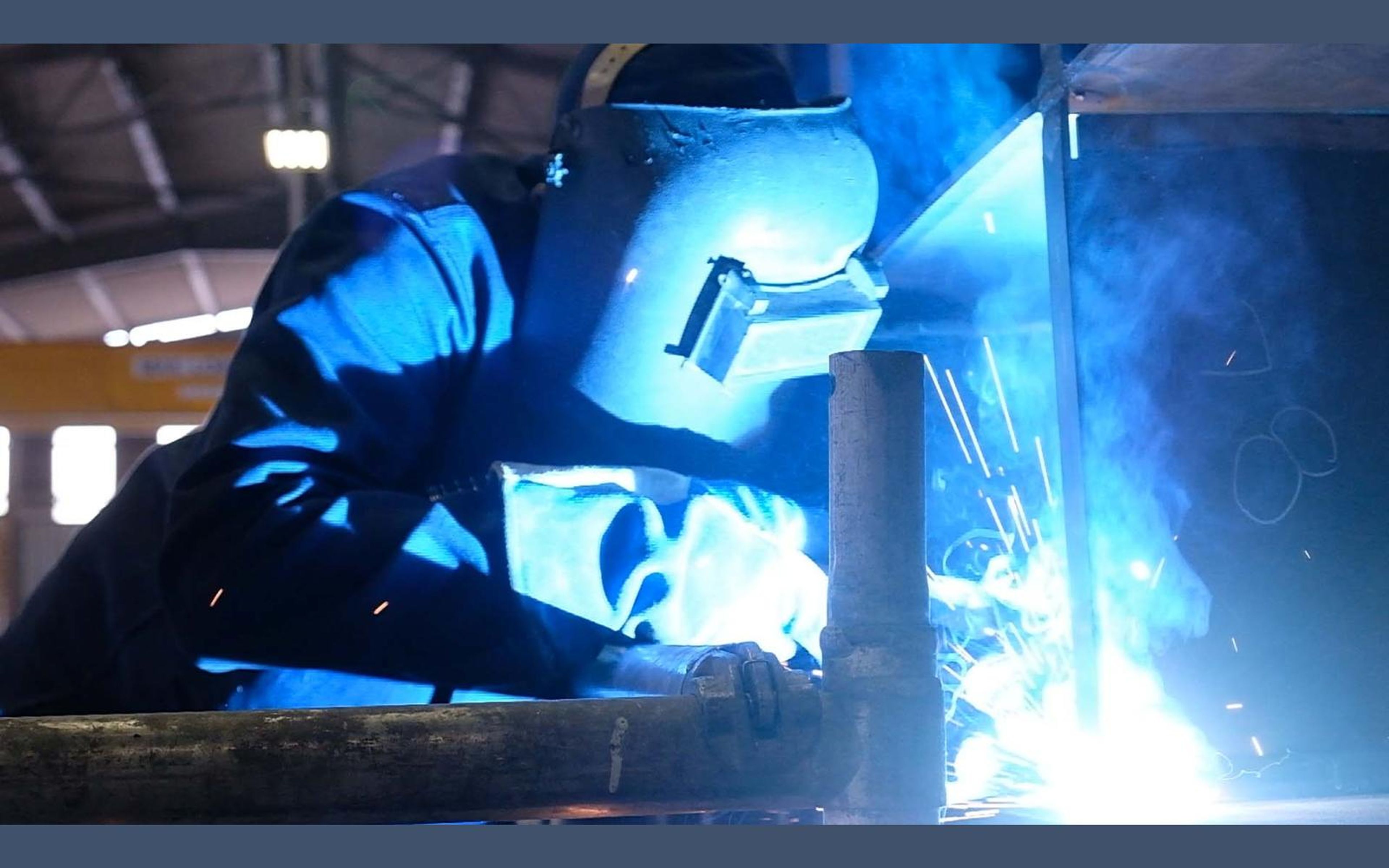Close view of a welder's torch and glowing weld