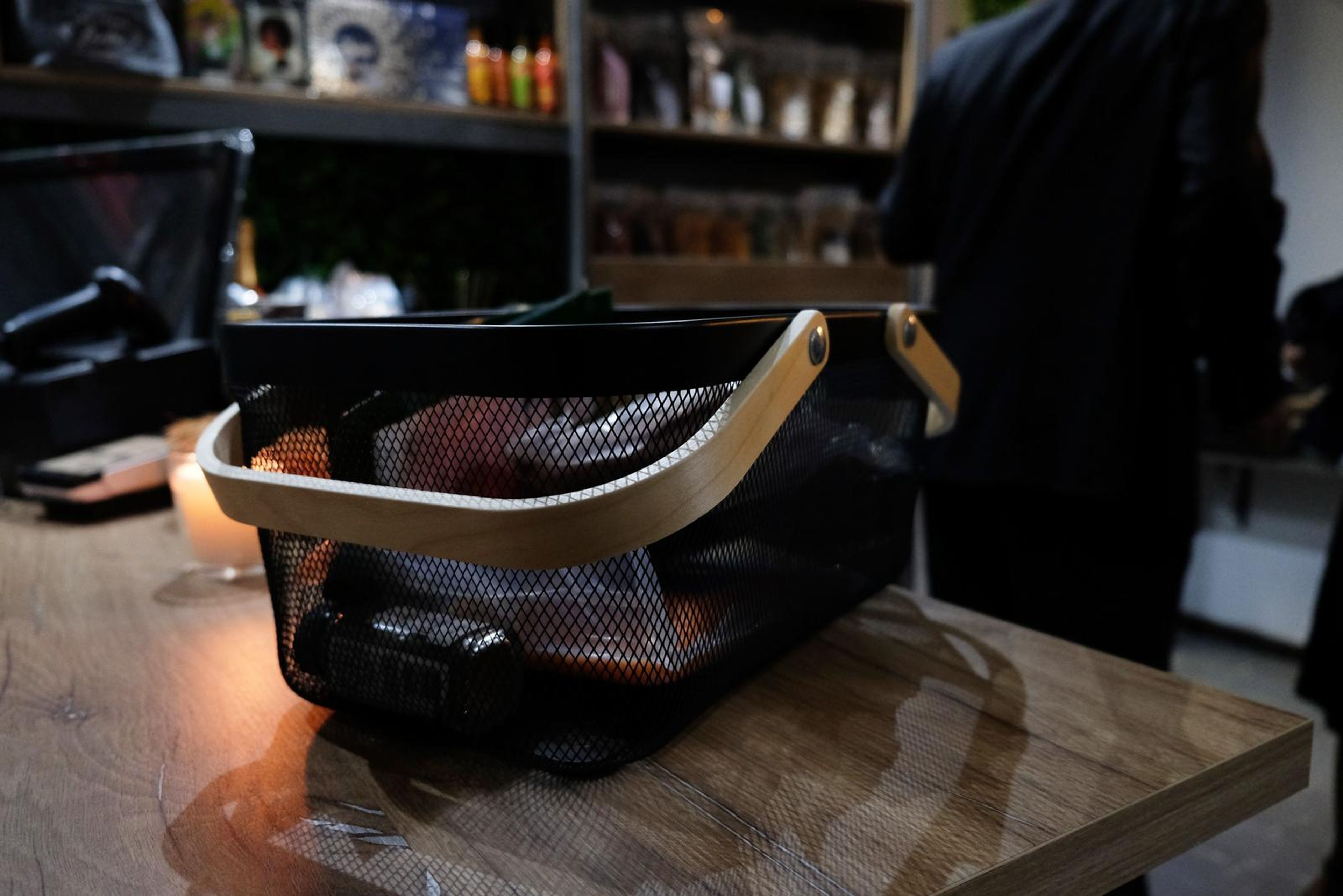 Basket and candle on the counter with guests behind