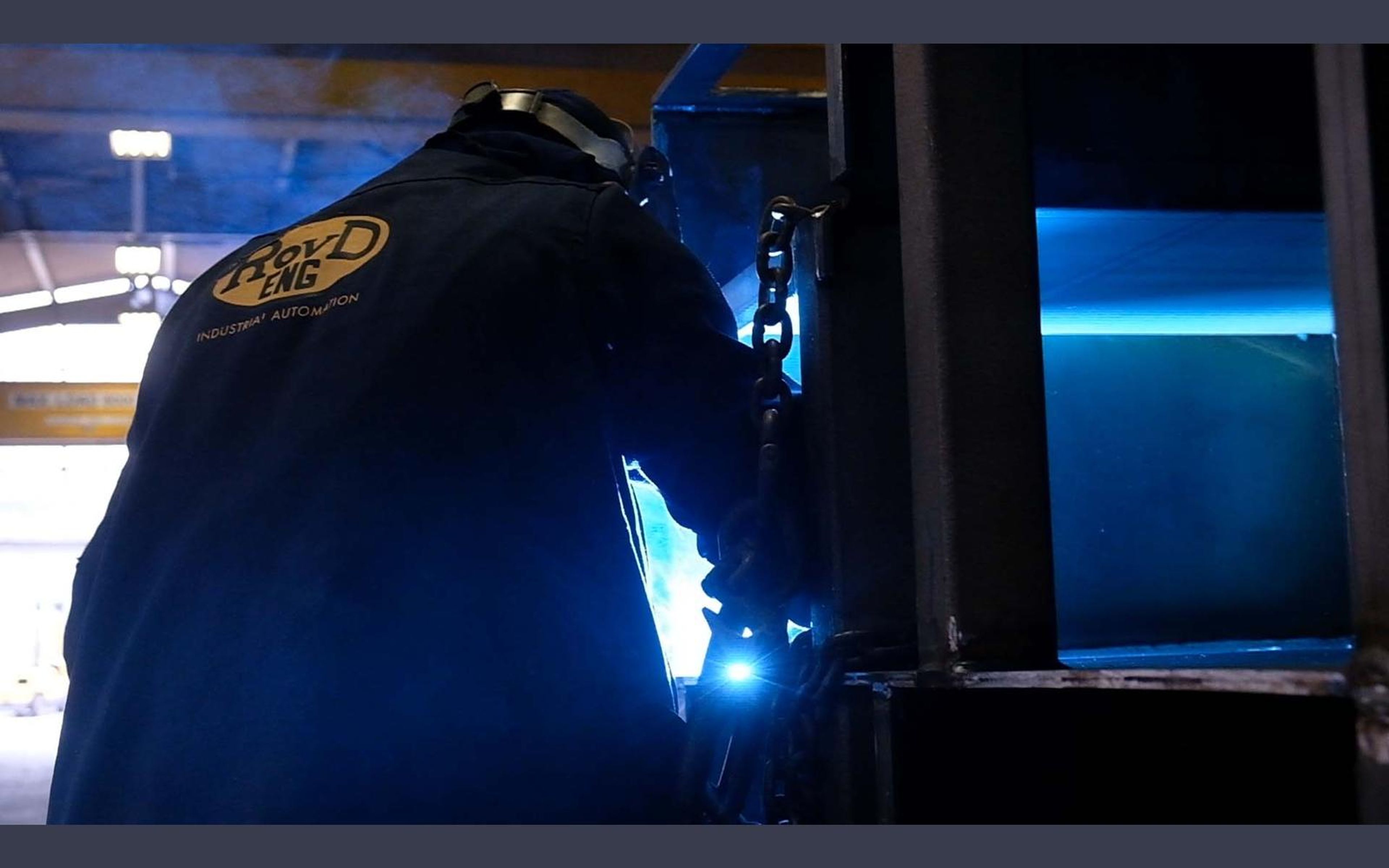 Welder at work with sparks and arc light