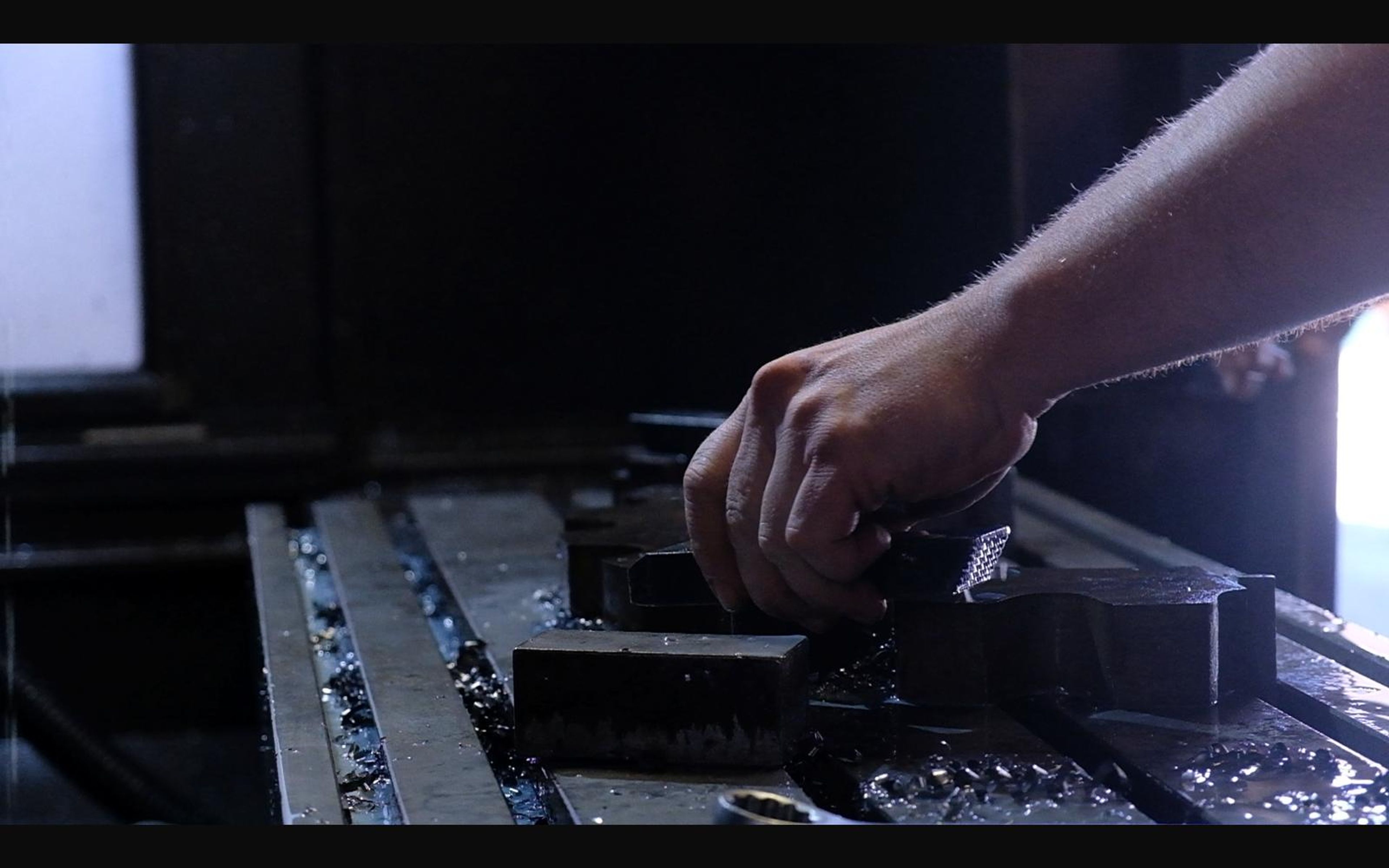 Machinist adjusting a part on the milling table