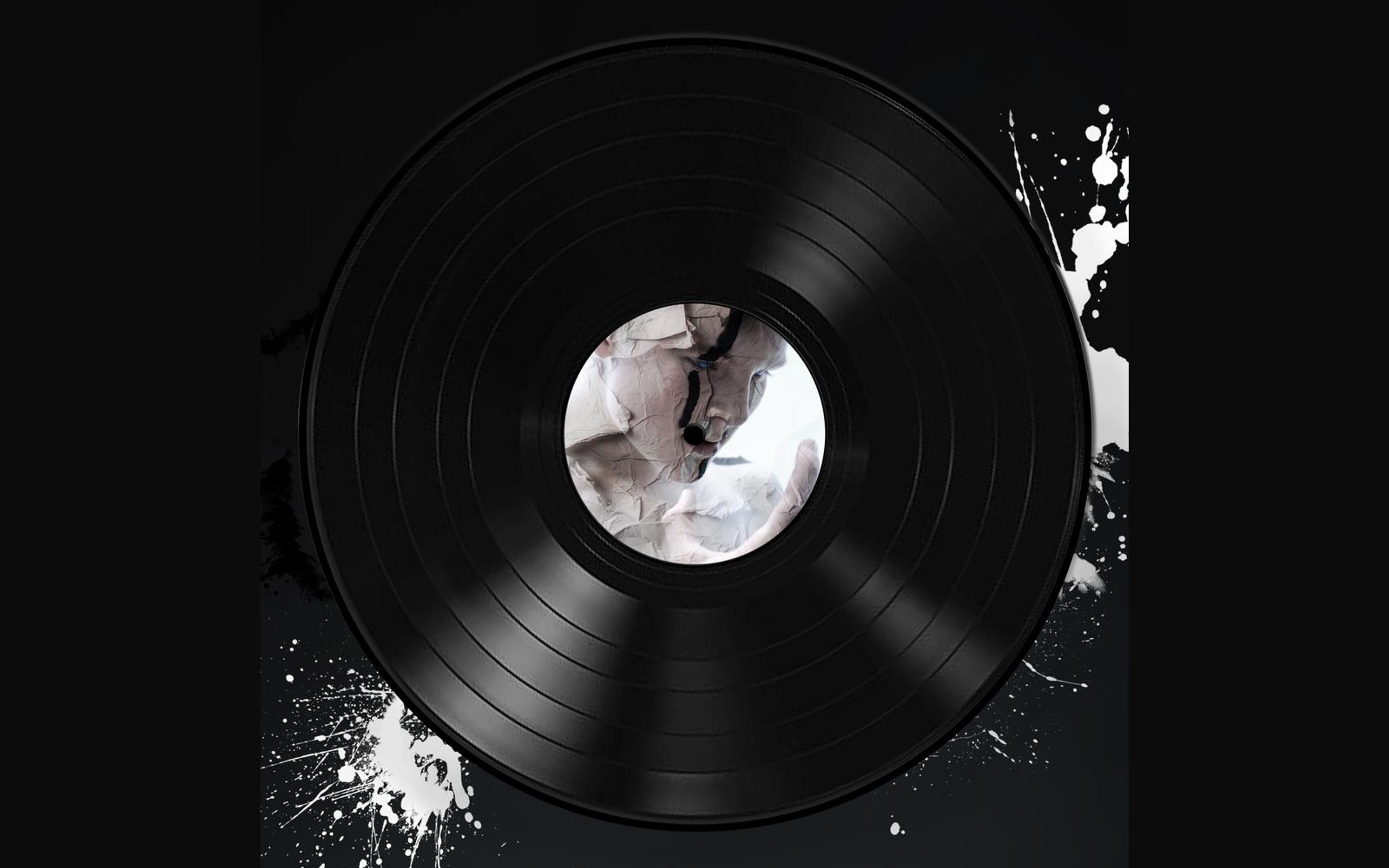 Vinyl record with a white sculptural face on its label and title lettering above