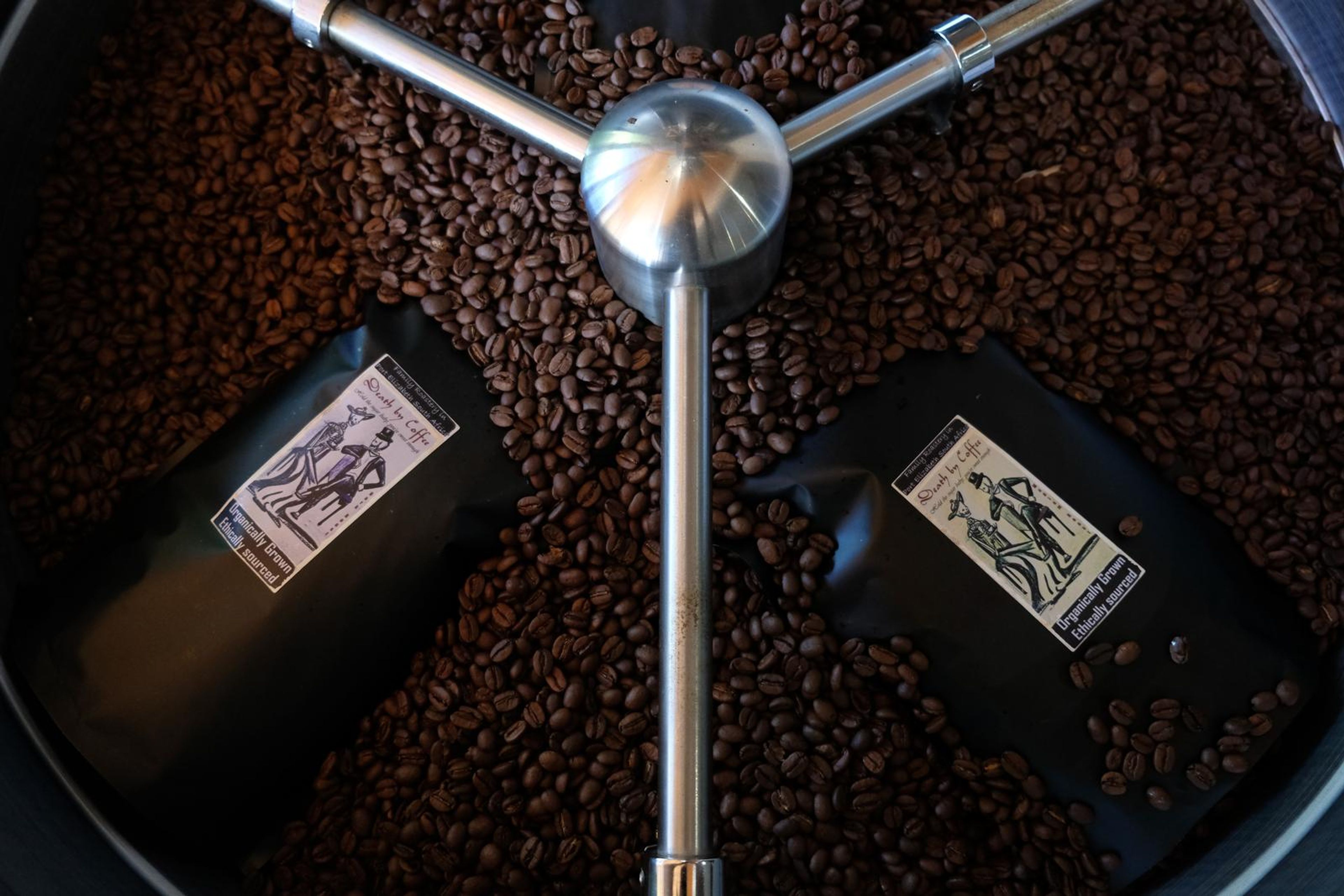 Death By Coffee creative product photography of coffee, beans and branded bags
