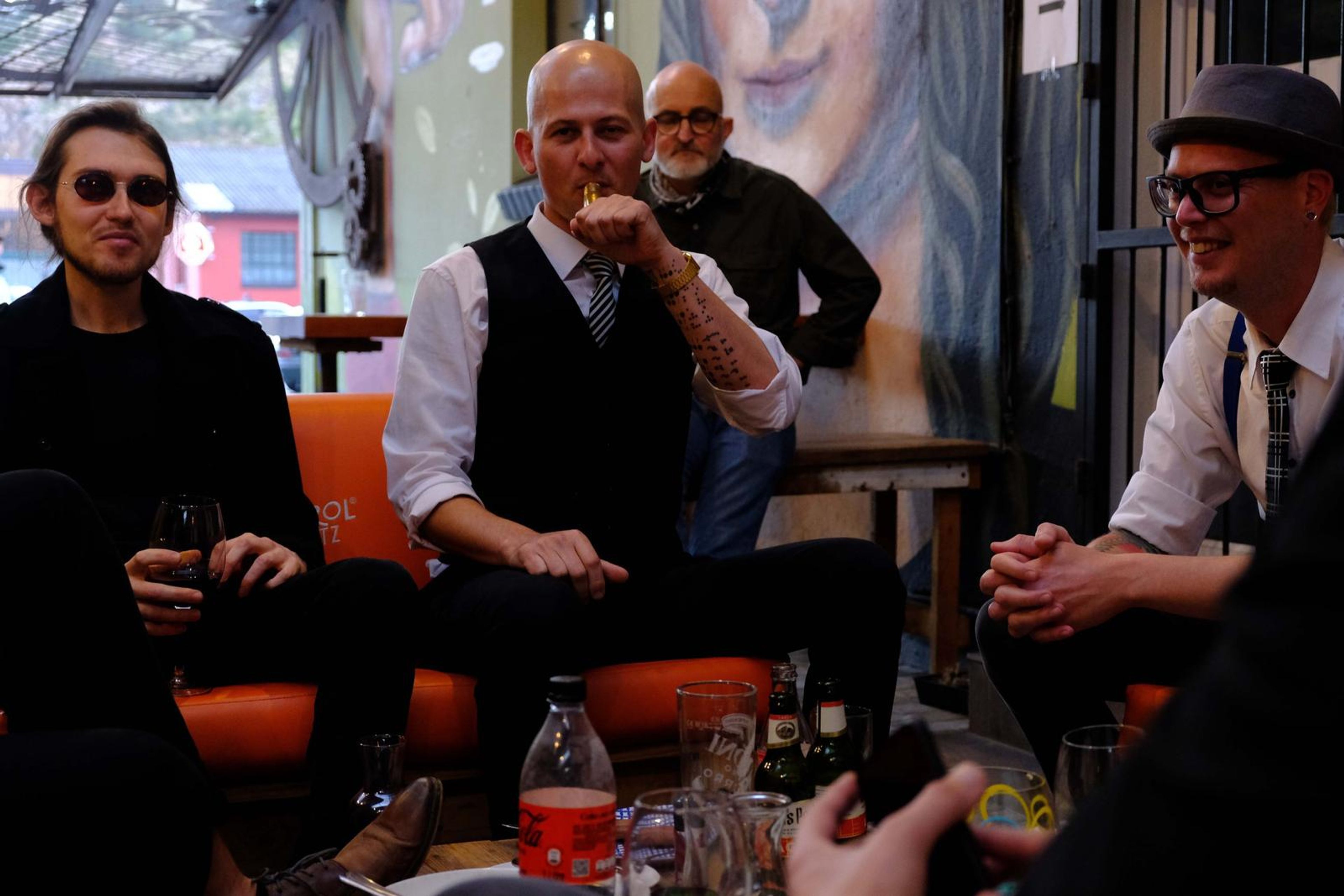 Band members relaxing on a sofa before the show