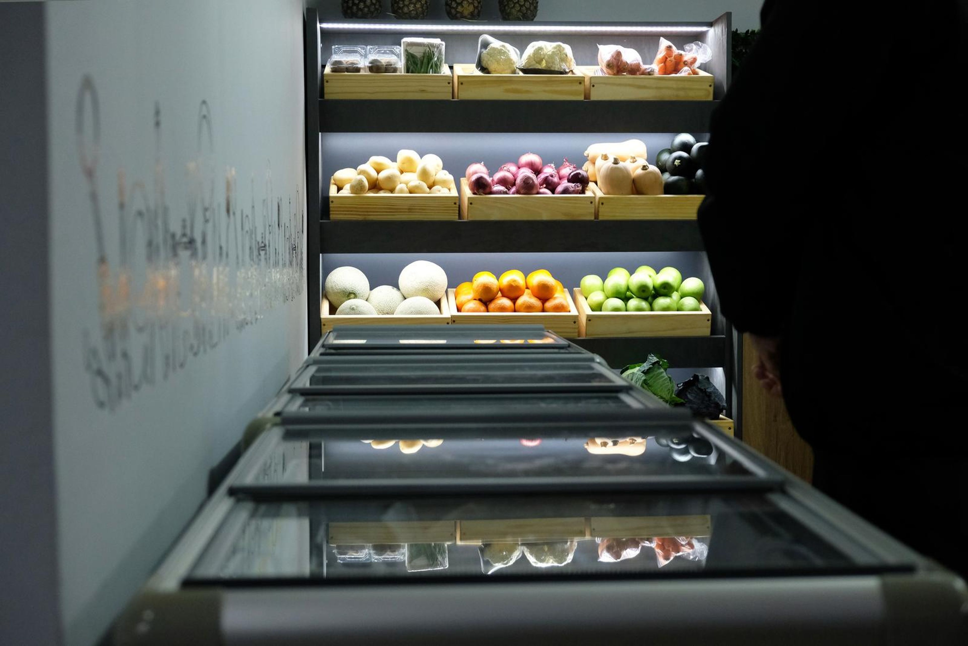 Low-angle view of the fruit and vegetable display along the freezer cabinets