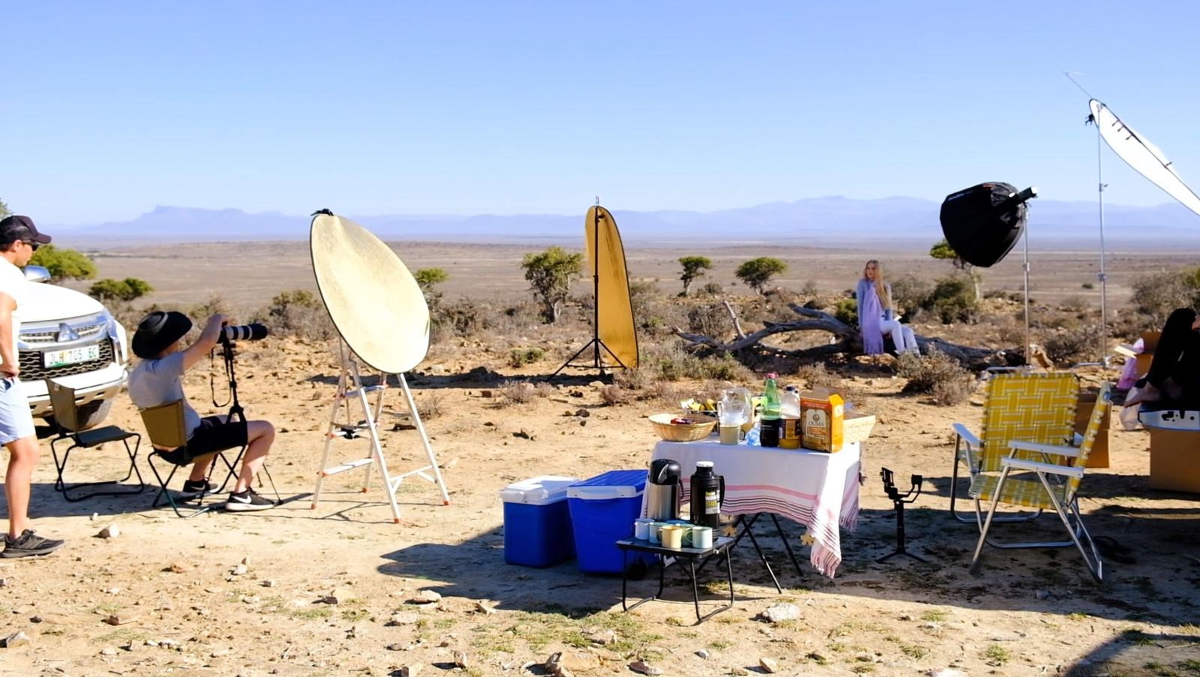 Camp set-up on the veld with reflectors, lights and a picnic table