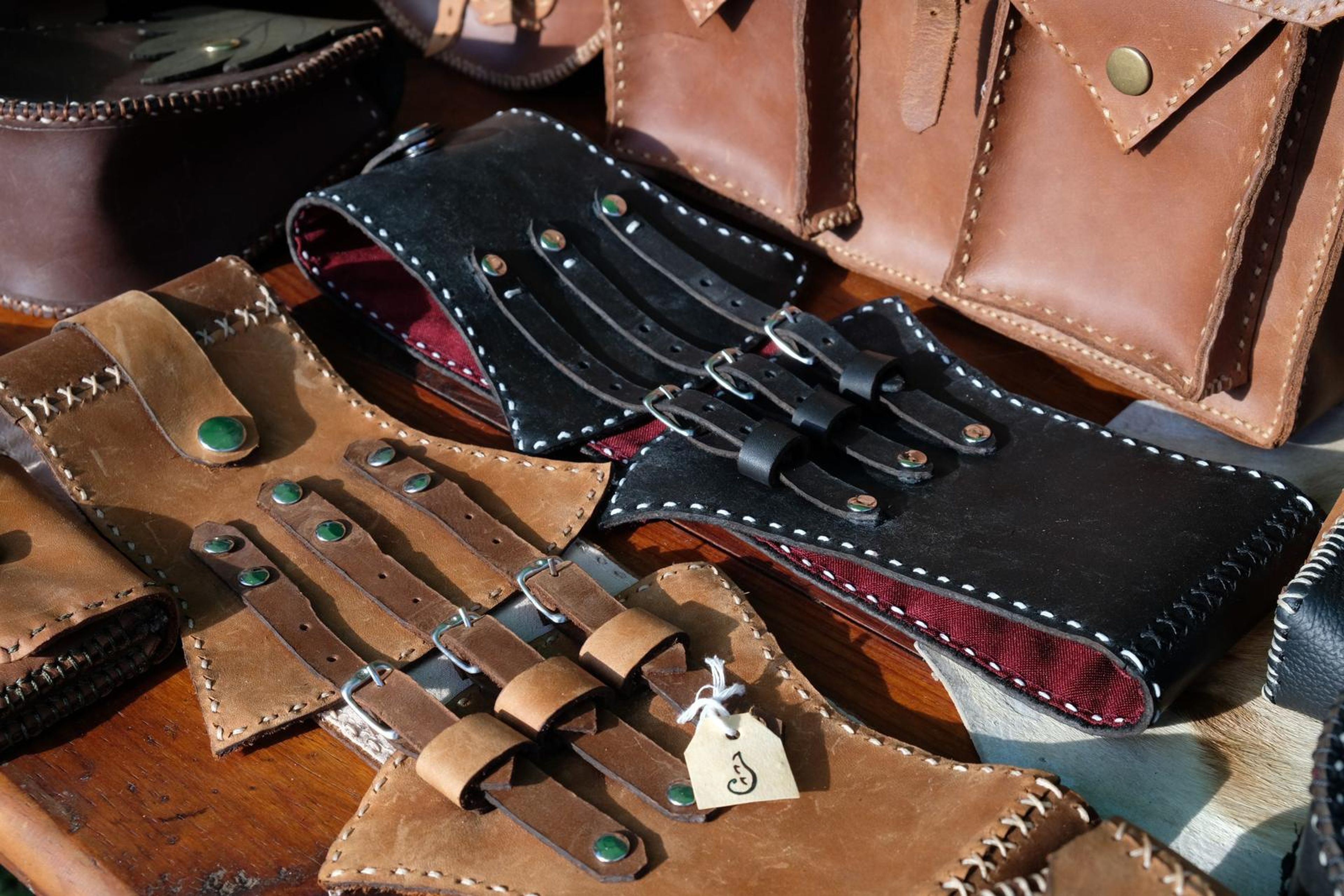 Tan and black leather corset belts with buckled straps