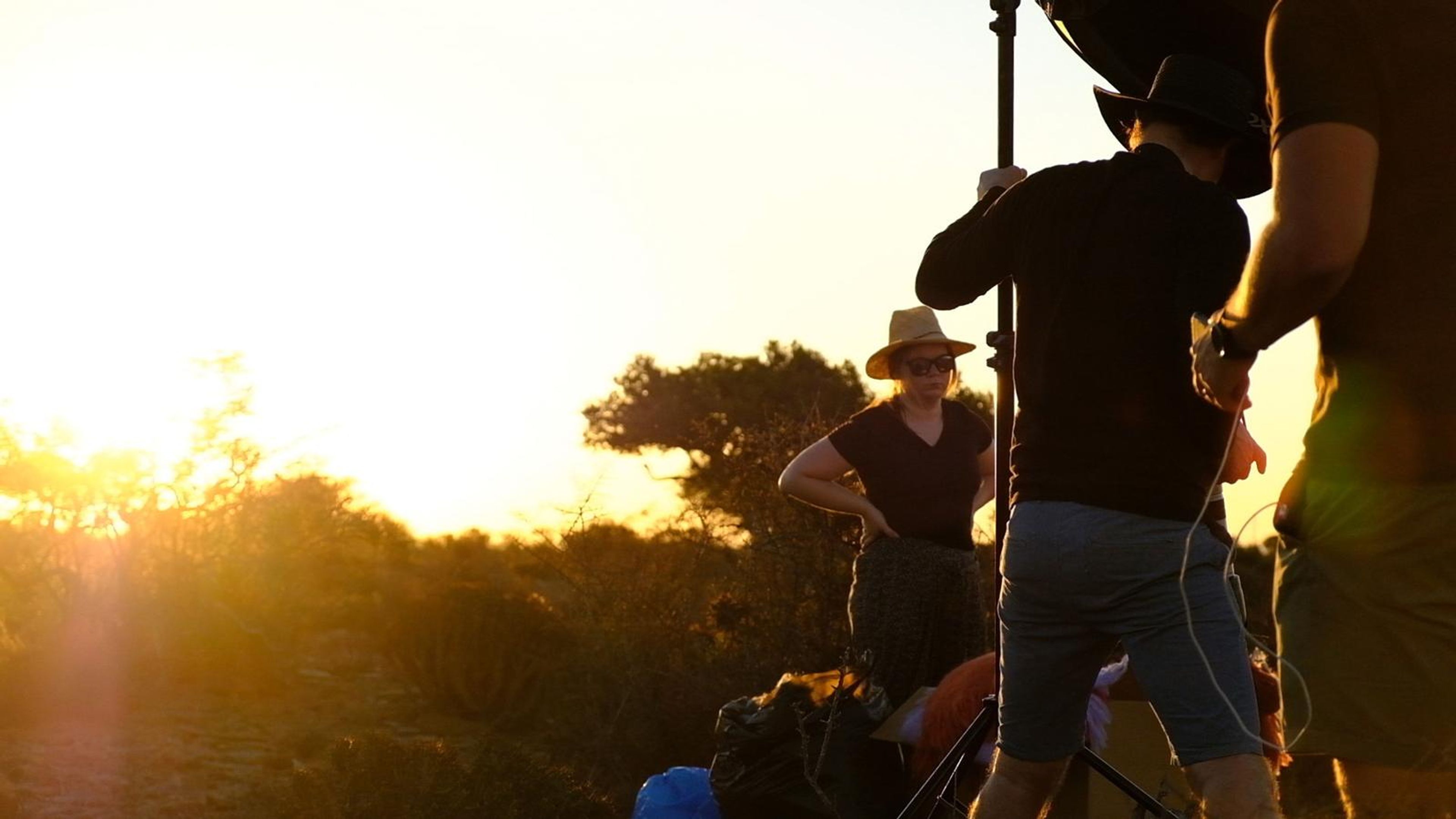 Crew silhouetted against the setting sun