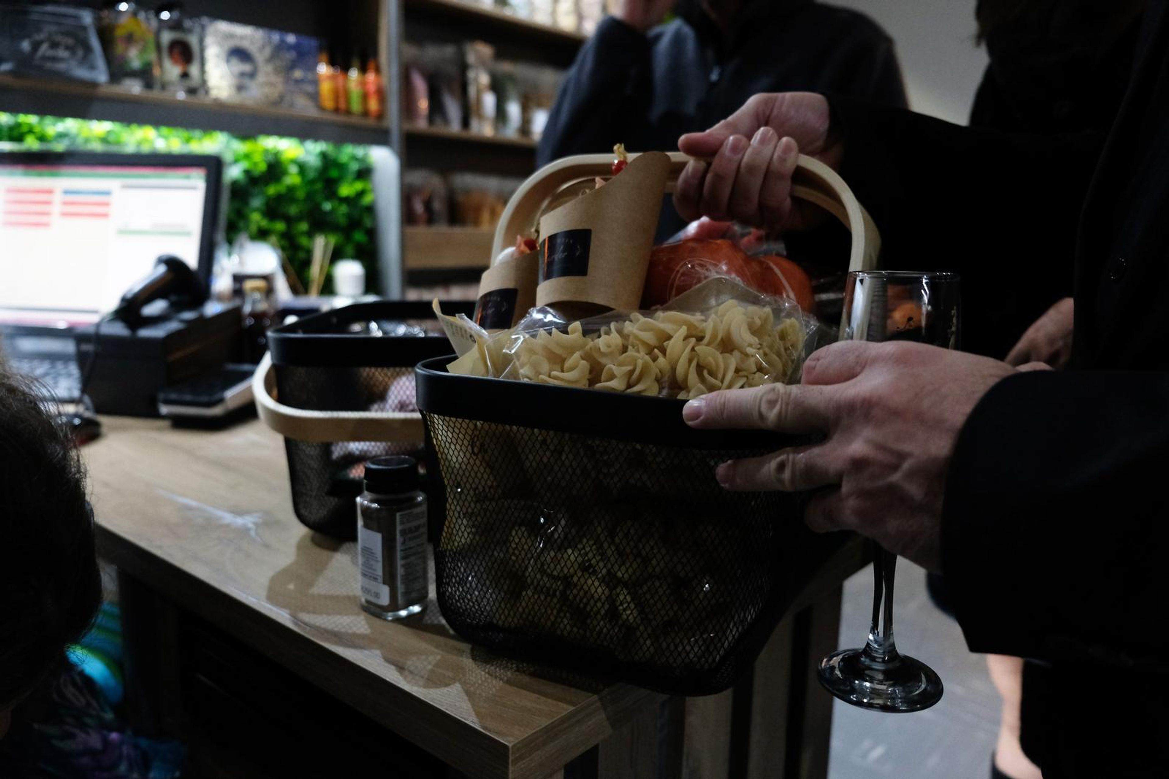 Basket of pasta and tomatoes at the till