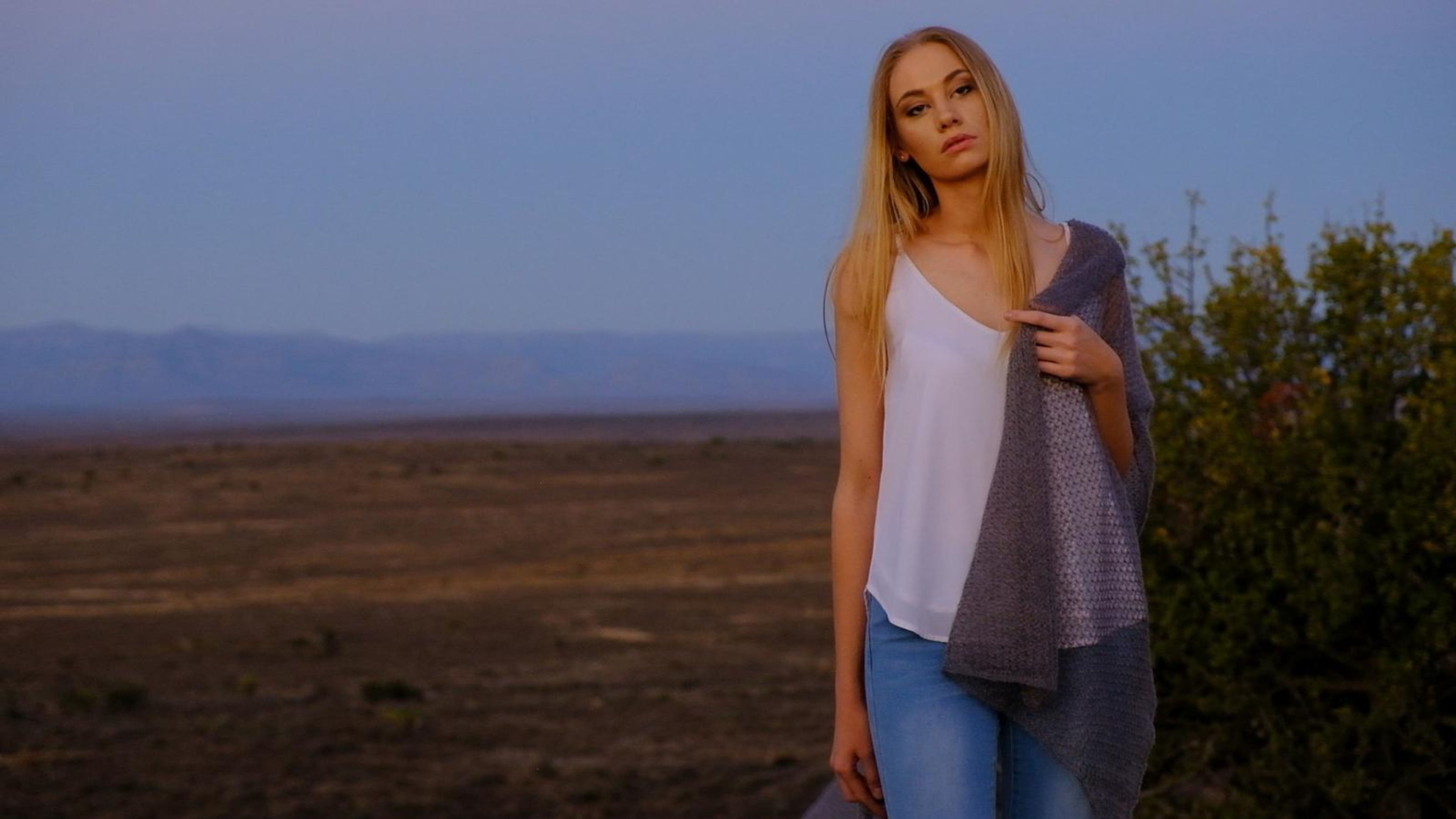 Model in a white top and grey mohair wrap at dusk