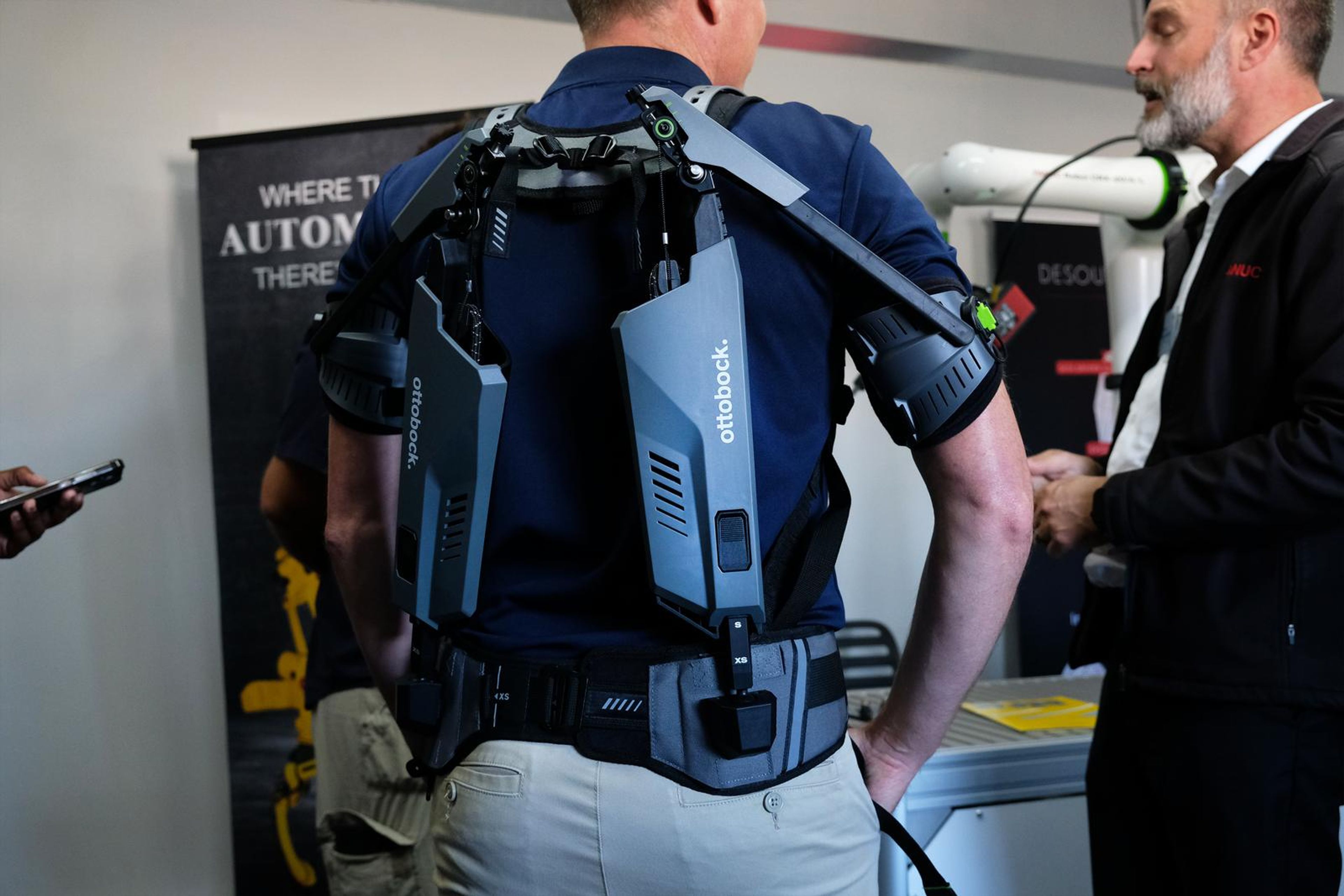 Exoskeleton worn on a visitor's back at the SuitX stand