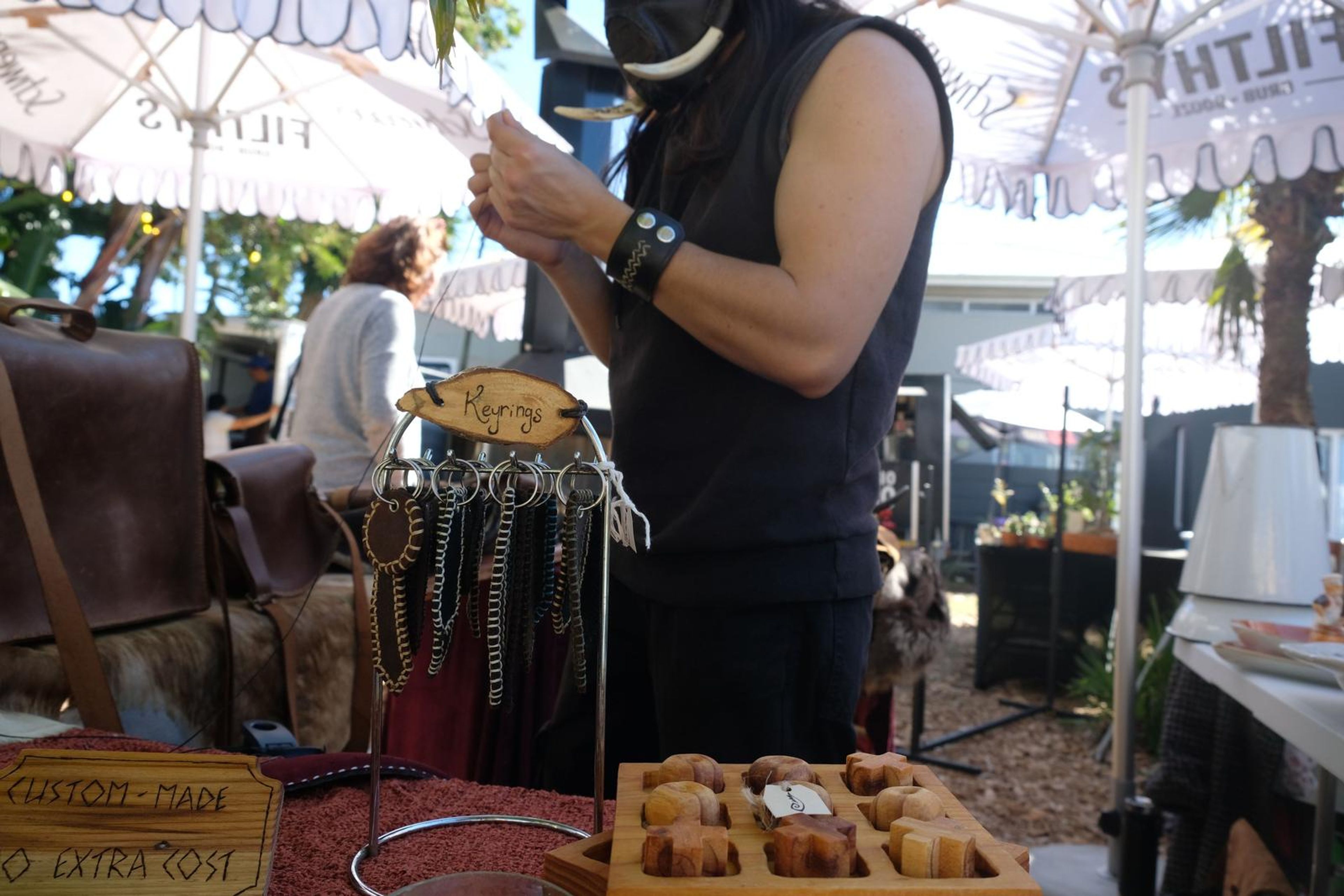 Juuks maker arranging leather goods and keyrings at the stall