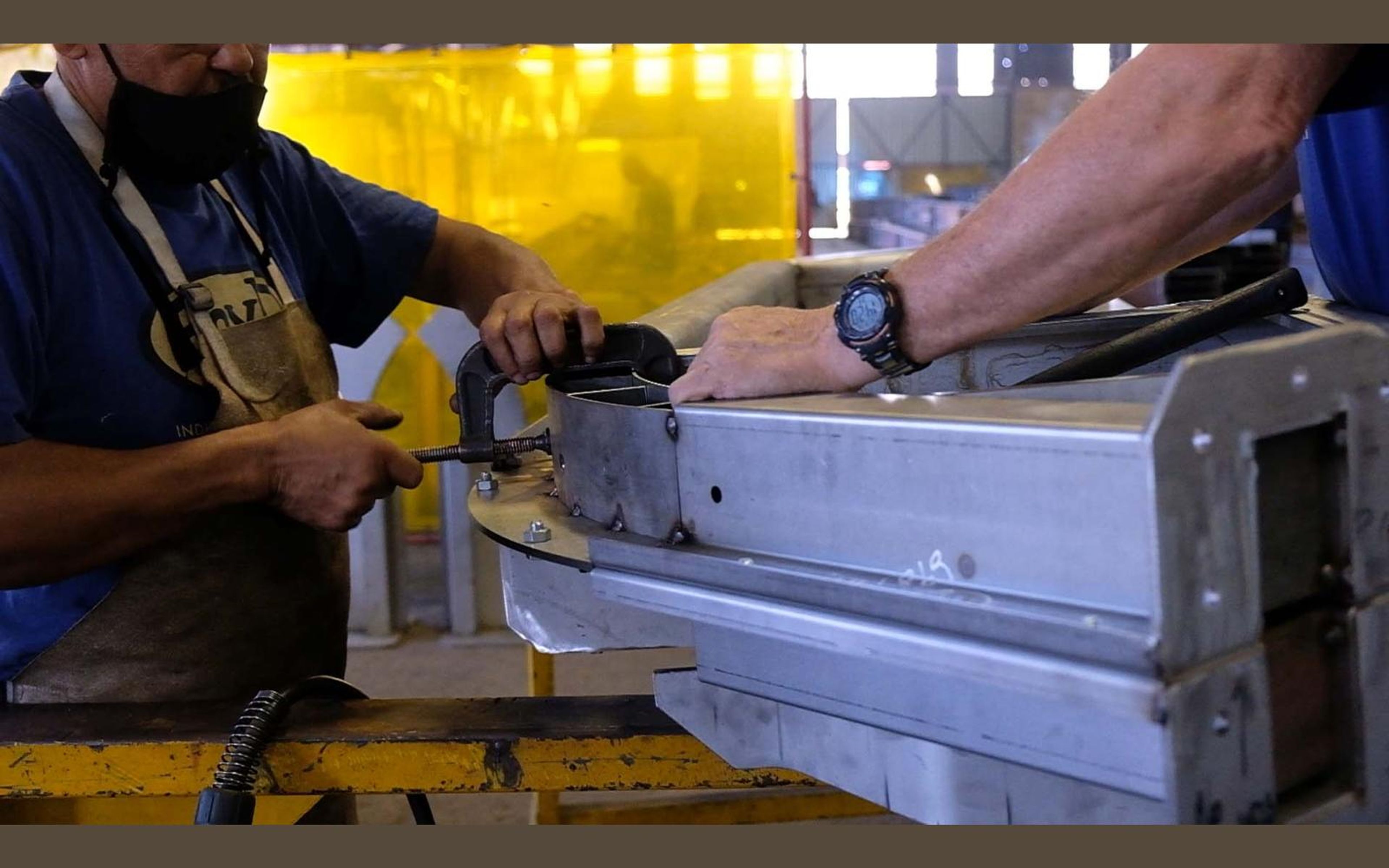 Fabricator in a ROVD Engineered to Work shirt at the bench