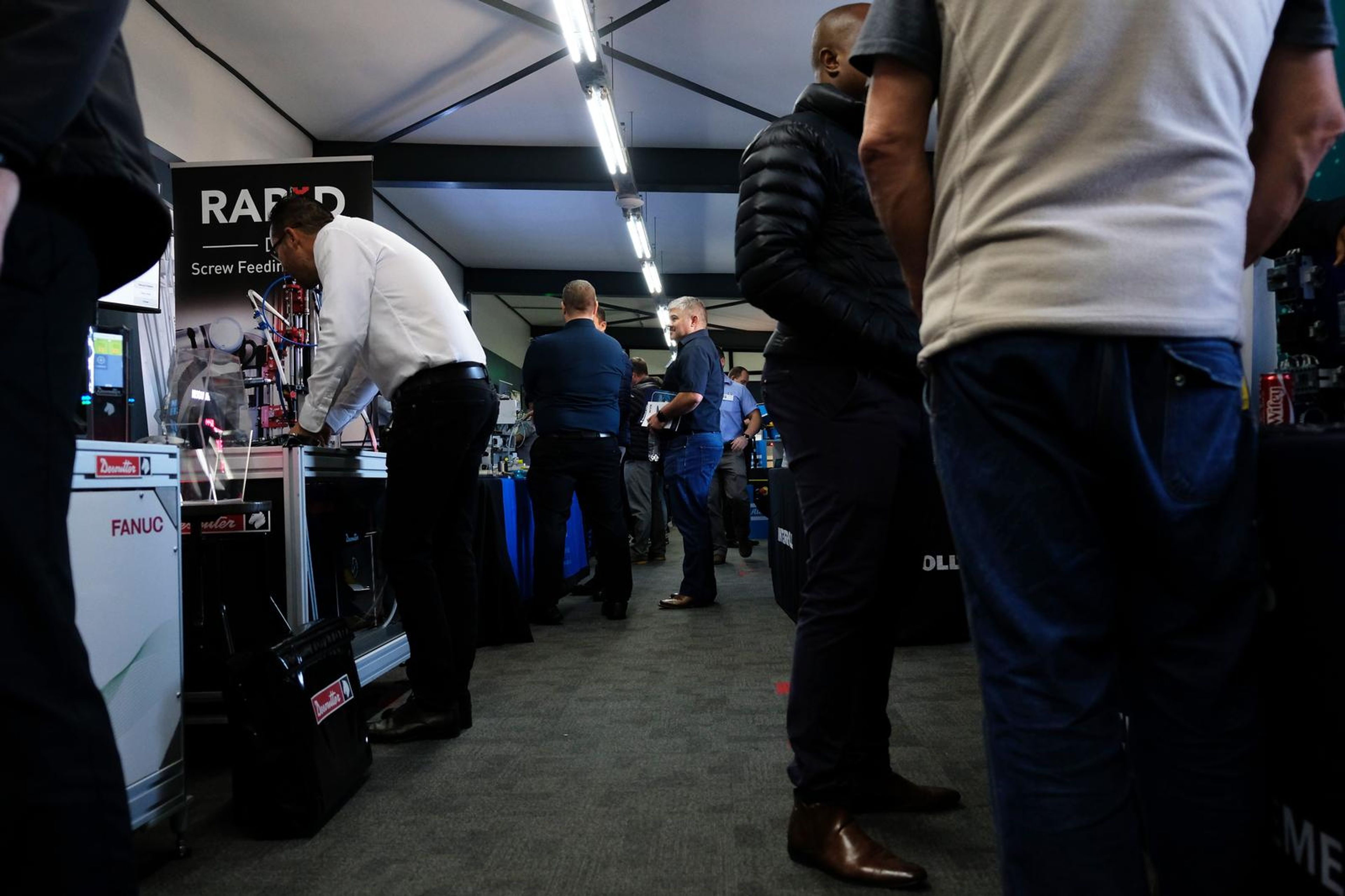 Visitors moving between stands in the expo hall