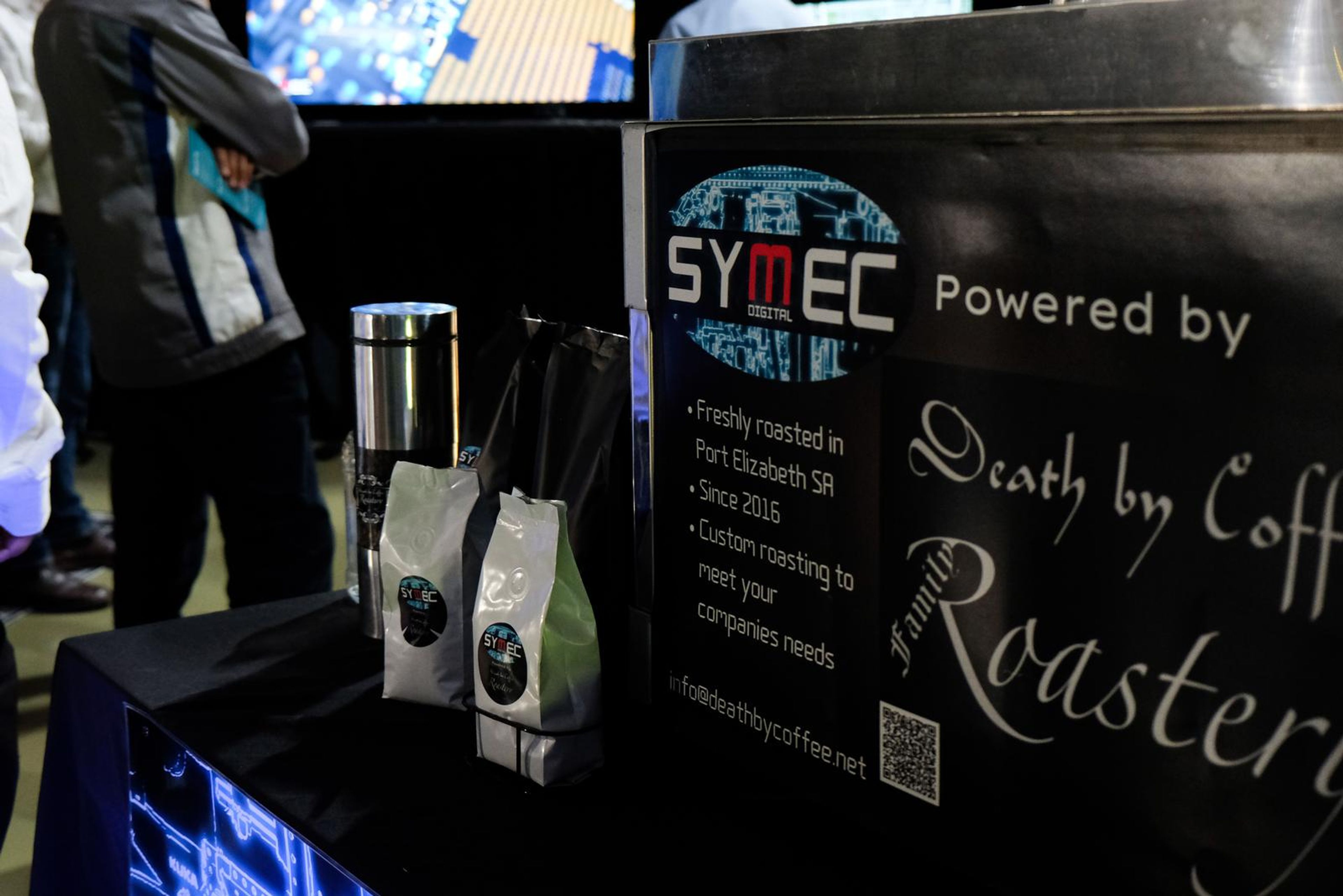 Death by Coffee Roastery banner and coffee bags at the Symec stall