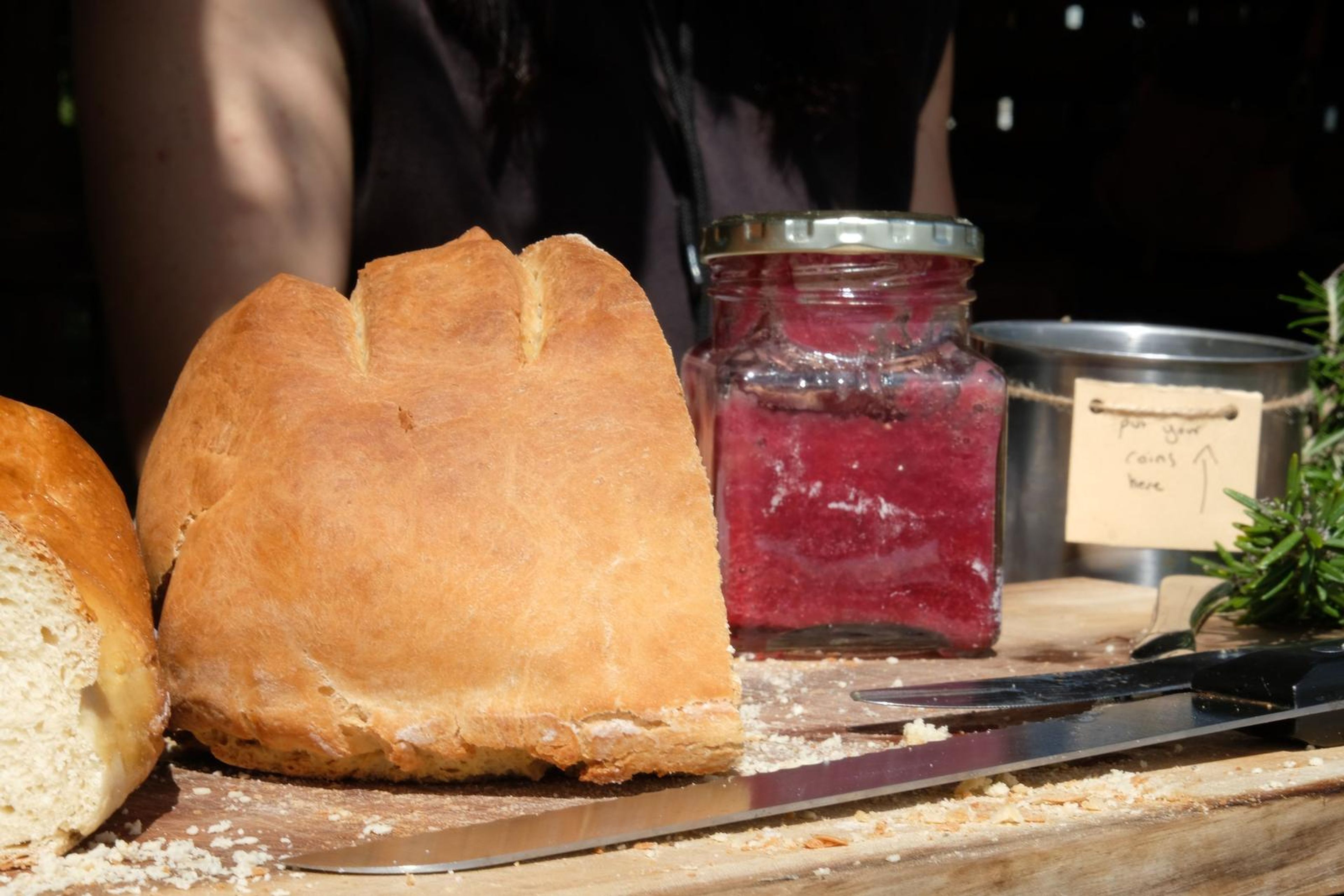 Neighbouring stall table with bread, jam and herbs at Windsong Boho market
