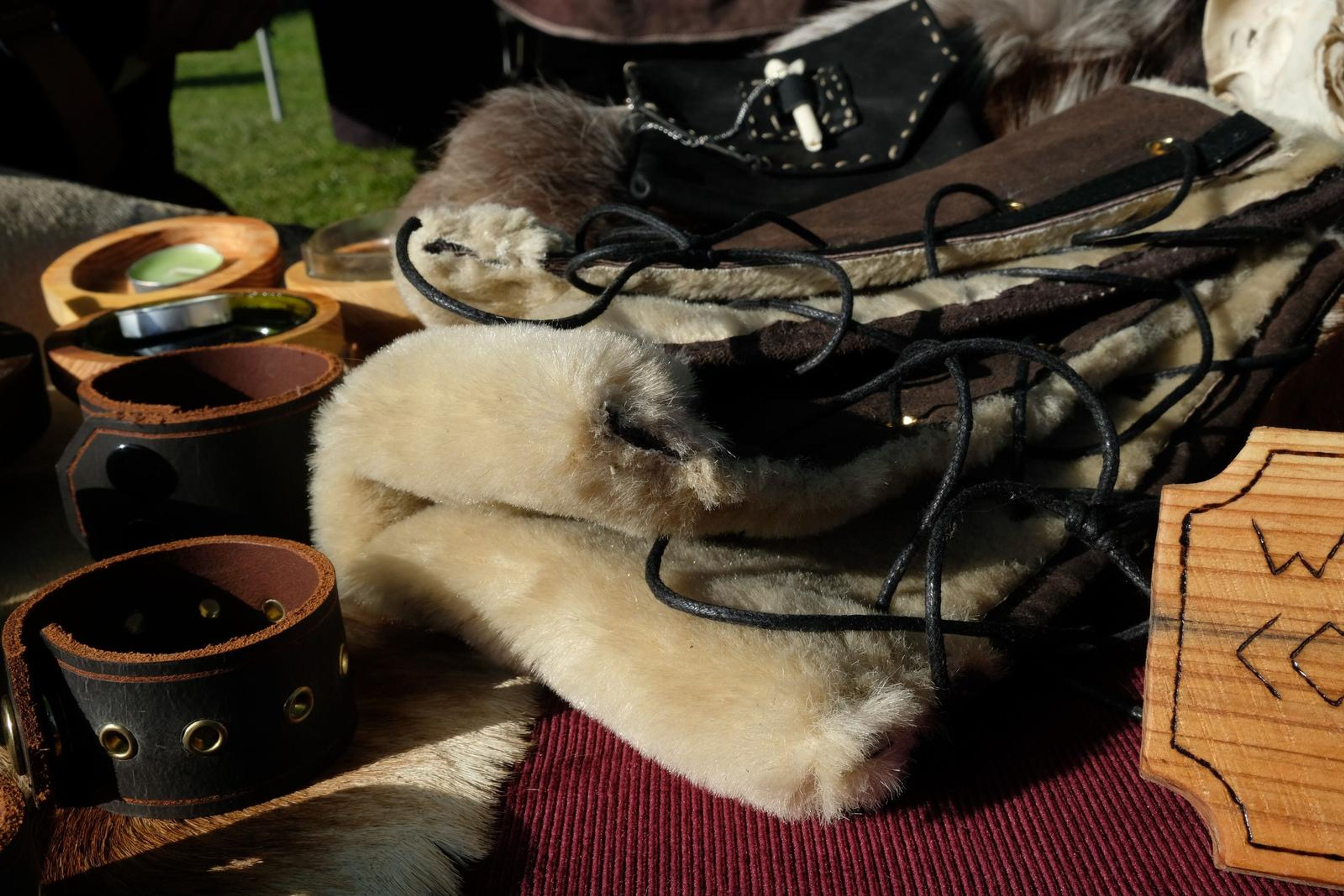 Fur-lined leather arm wraps with lacing, a Winter Is Coming sign and animal skull