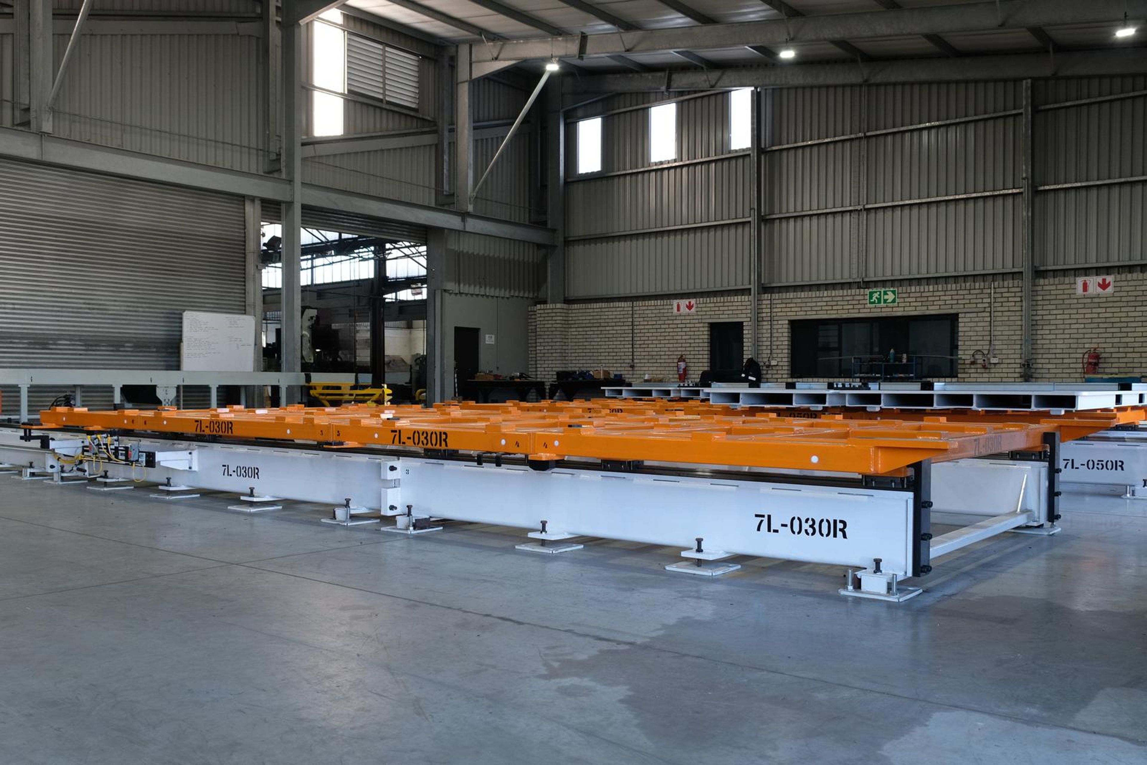 Orange and white tool stencilled 7L-030R across the plant floor