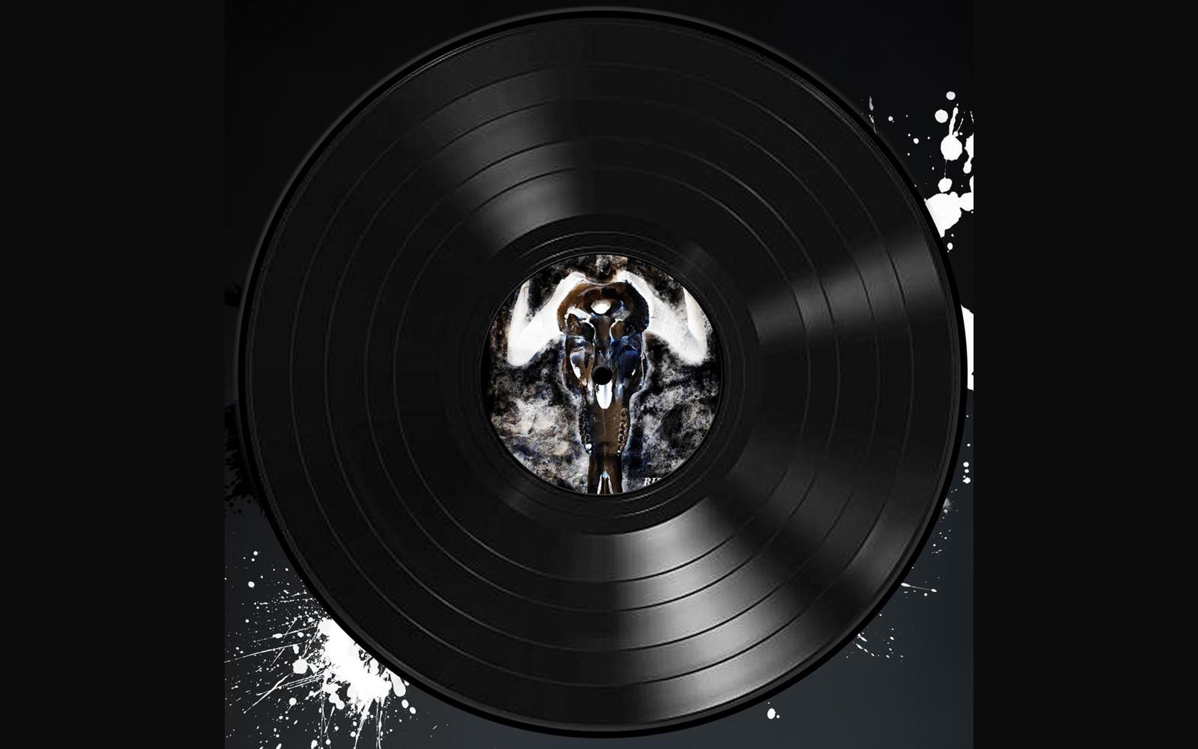 Vinyl record sleeve with a symmetrical dark horned figure on the centre label, white paint splatter in the corners