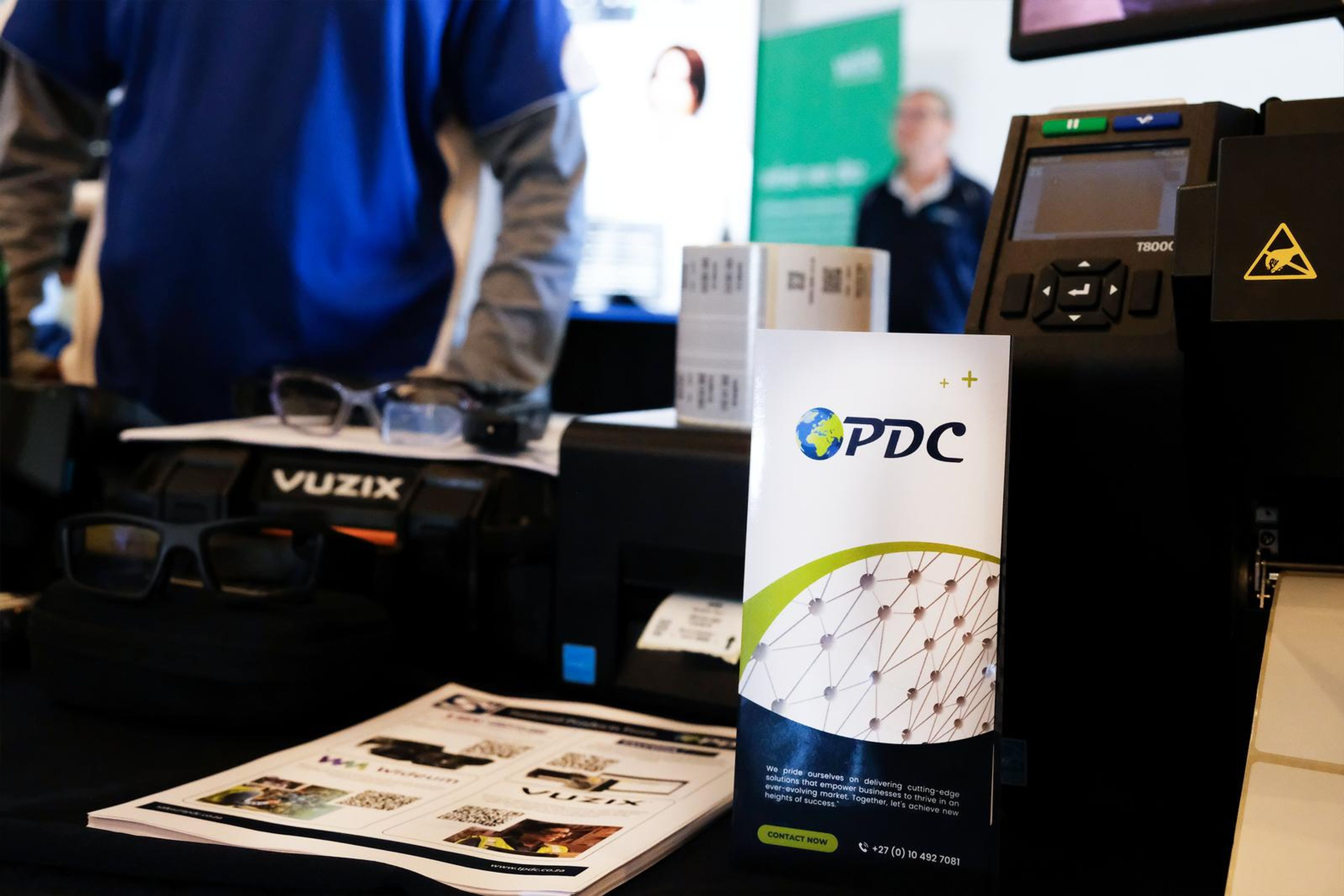 PDC stand with a printer and sign