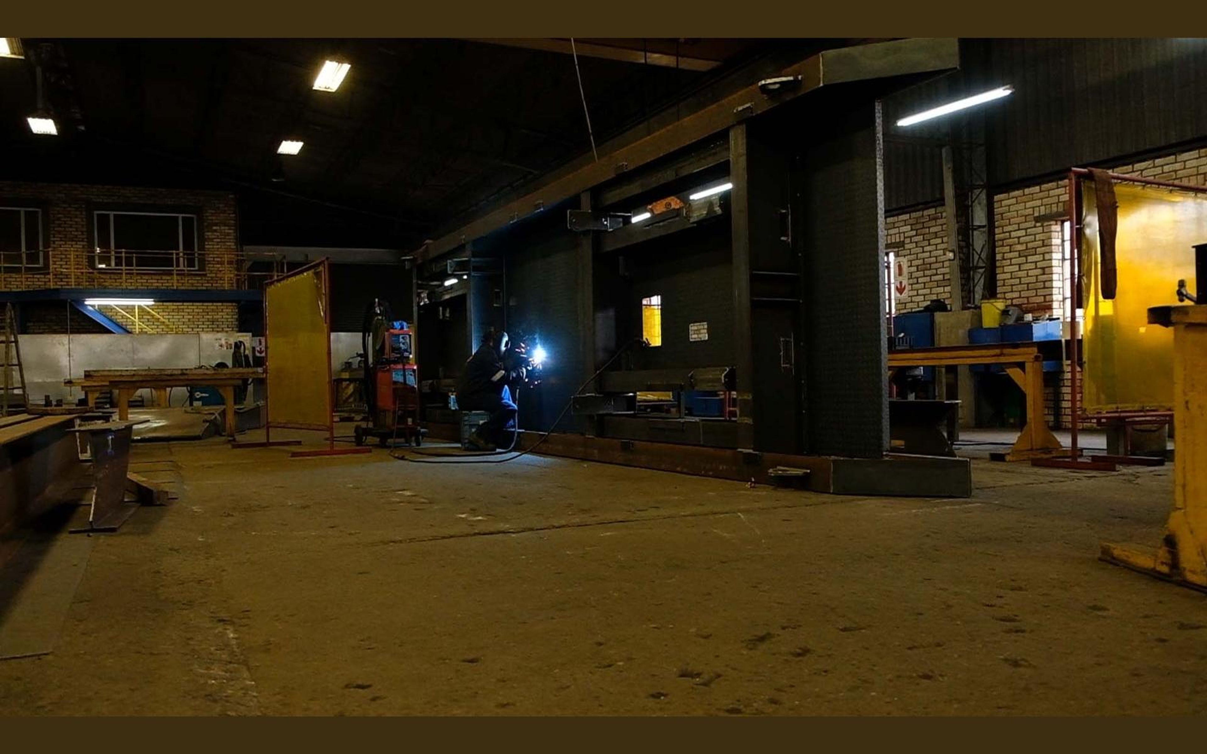Wide view of the fabrication sector with steel frames on the floor