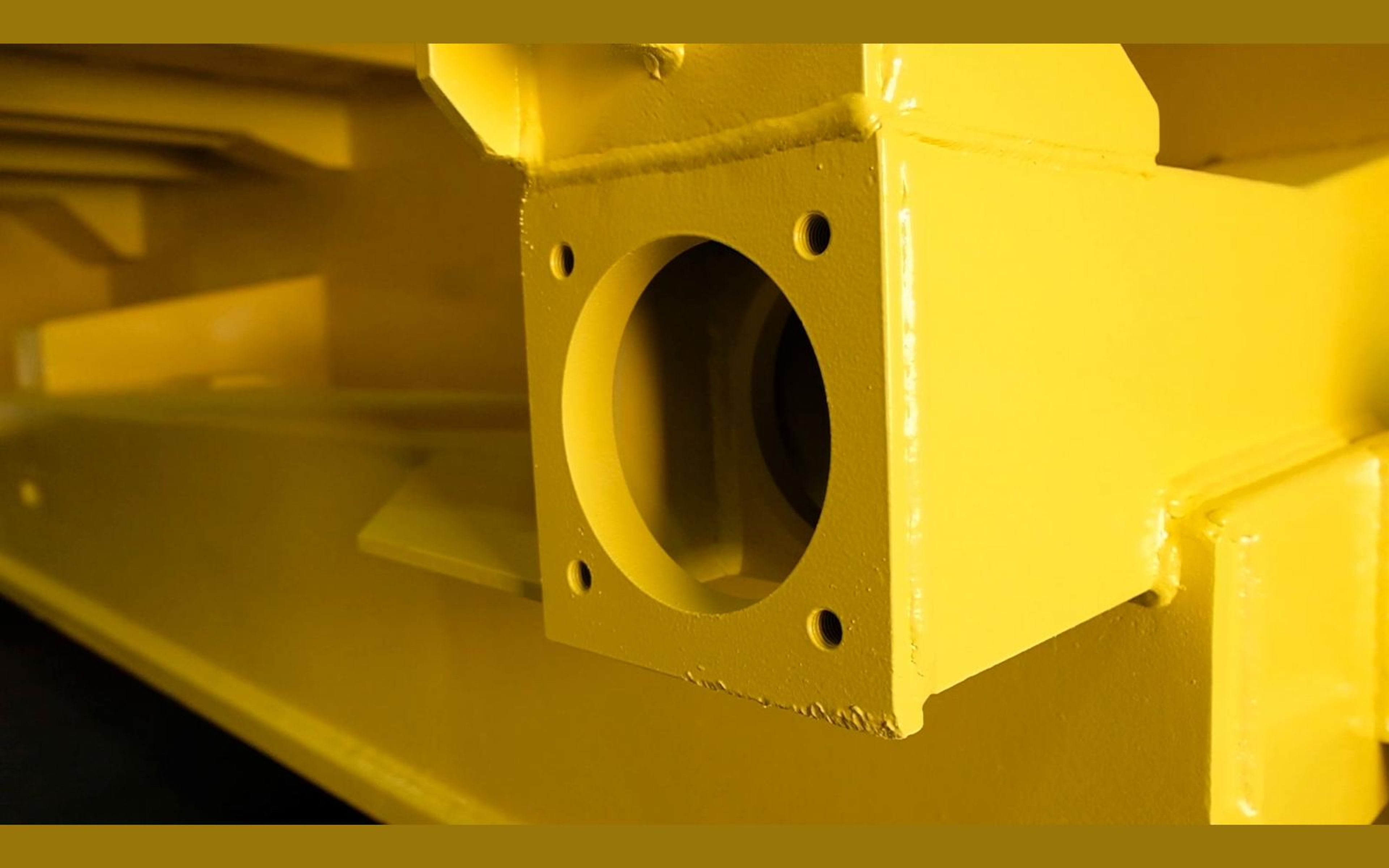 Painted yellow steel housing with a round opening