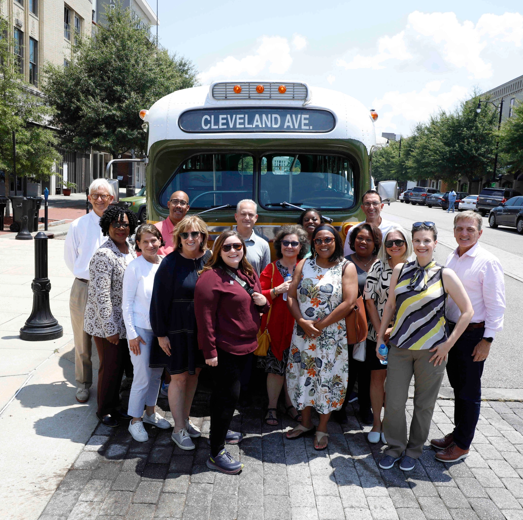 Group Tour standing in front of the Cleveland Ave Bus (replica)