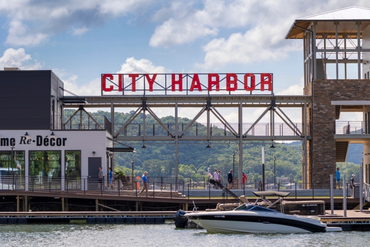 Waterfront scene at City Harbor, located at Lake Guntersville in northern Alabama between Bridgeport and Guntersville. This features a docked boat and a boardwalk with pedestrians.