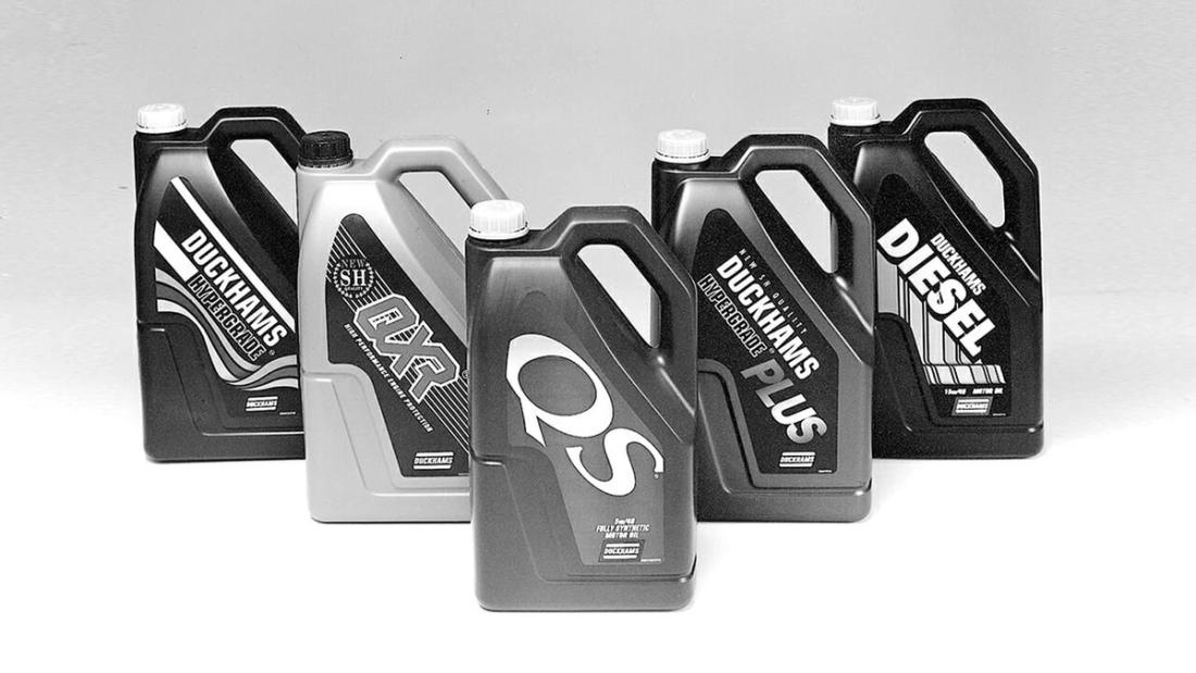Five Duckhams plastic oil bottles grouped together, including QS and a diesel grade.