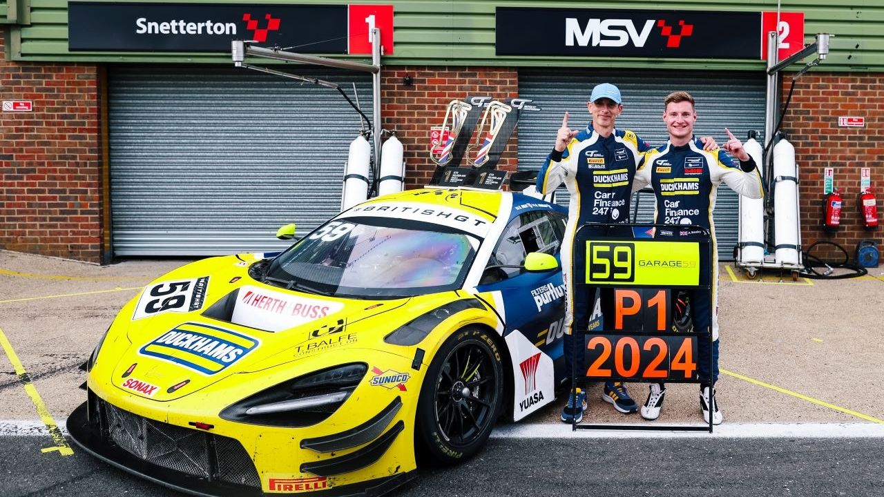 Two drivers beside the yellow Duckhams McLaren GT3 holding a board reading P1 2024.