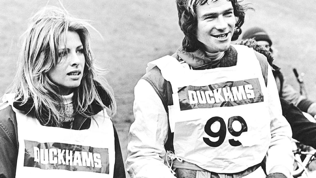 A woman and a rider, both in Duckhams-branded bibs numbered 90.